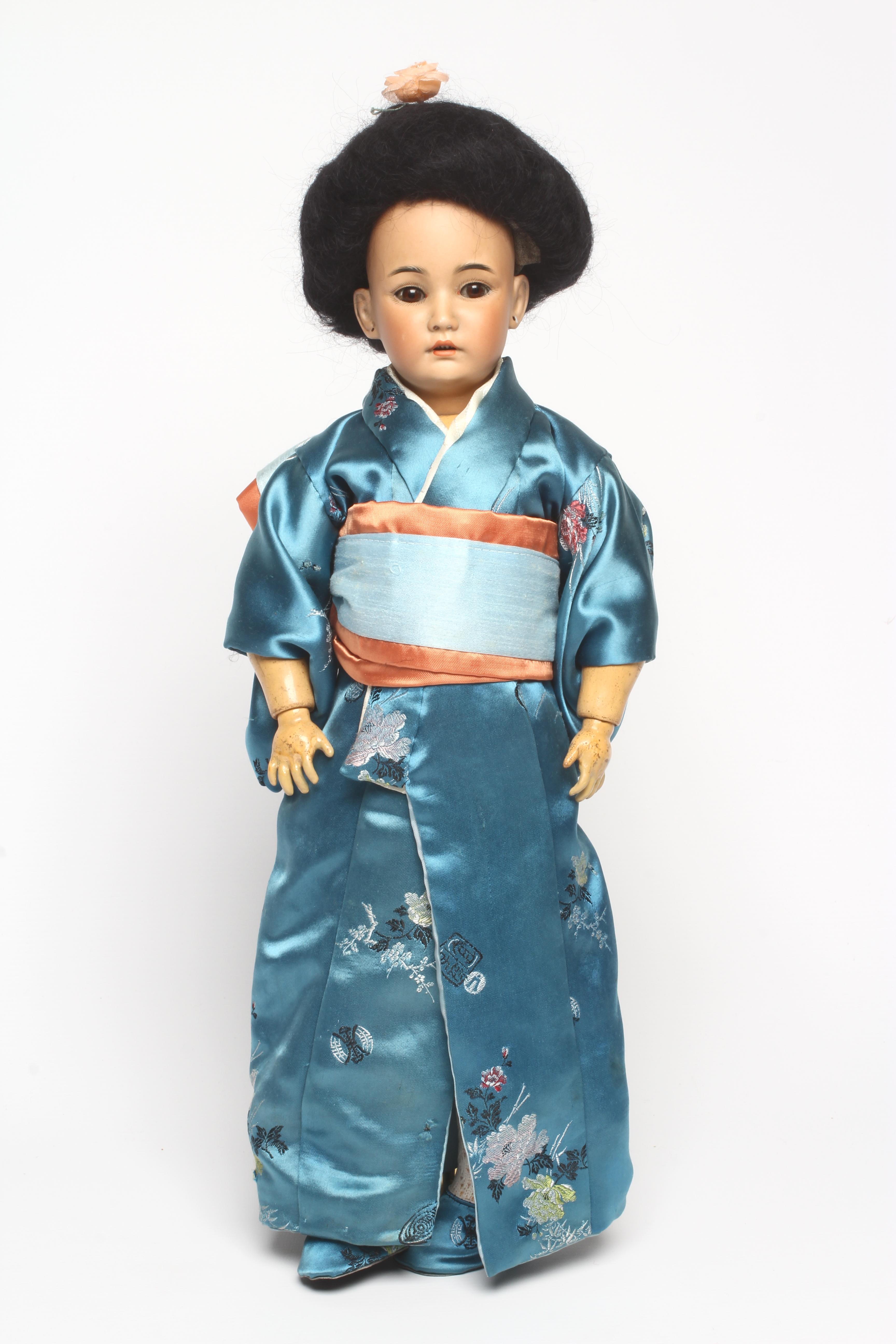 A Simon & Halbig bisque socket head Asian doll with brown glass sleeping eyes Image