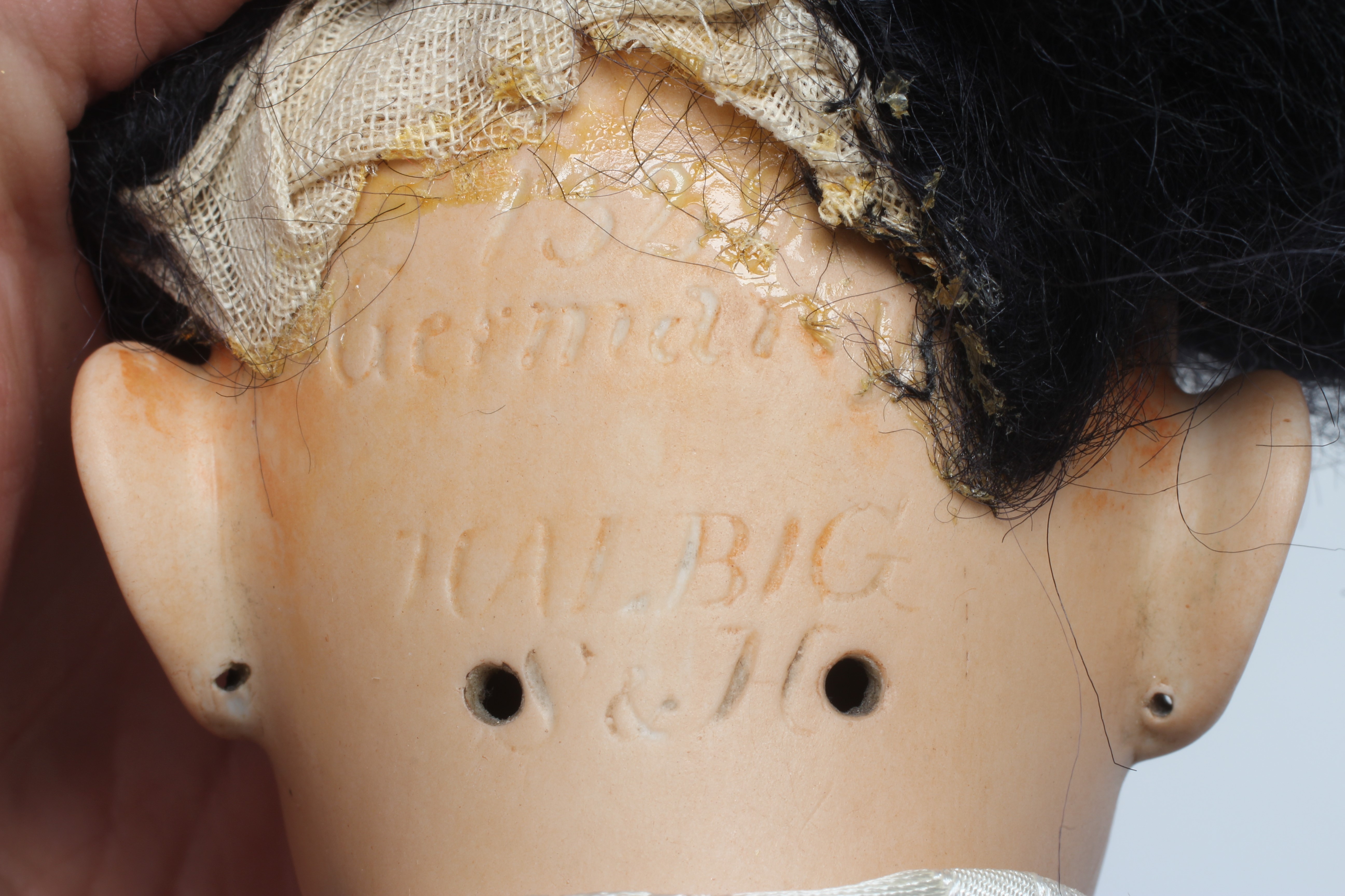 A Simon & Halbig bisque socket head Asian doll with brown glass sleeping eyes Image