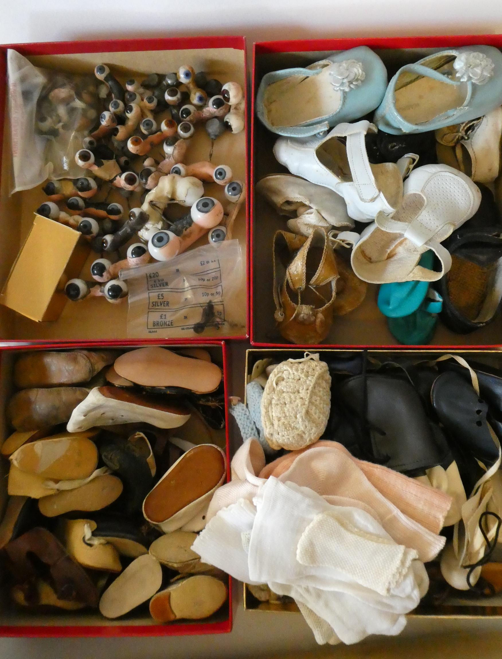 A box of antique and vintage dolls accessories including shoes, socks and glass eyes (Est. plus 24% Image