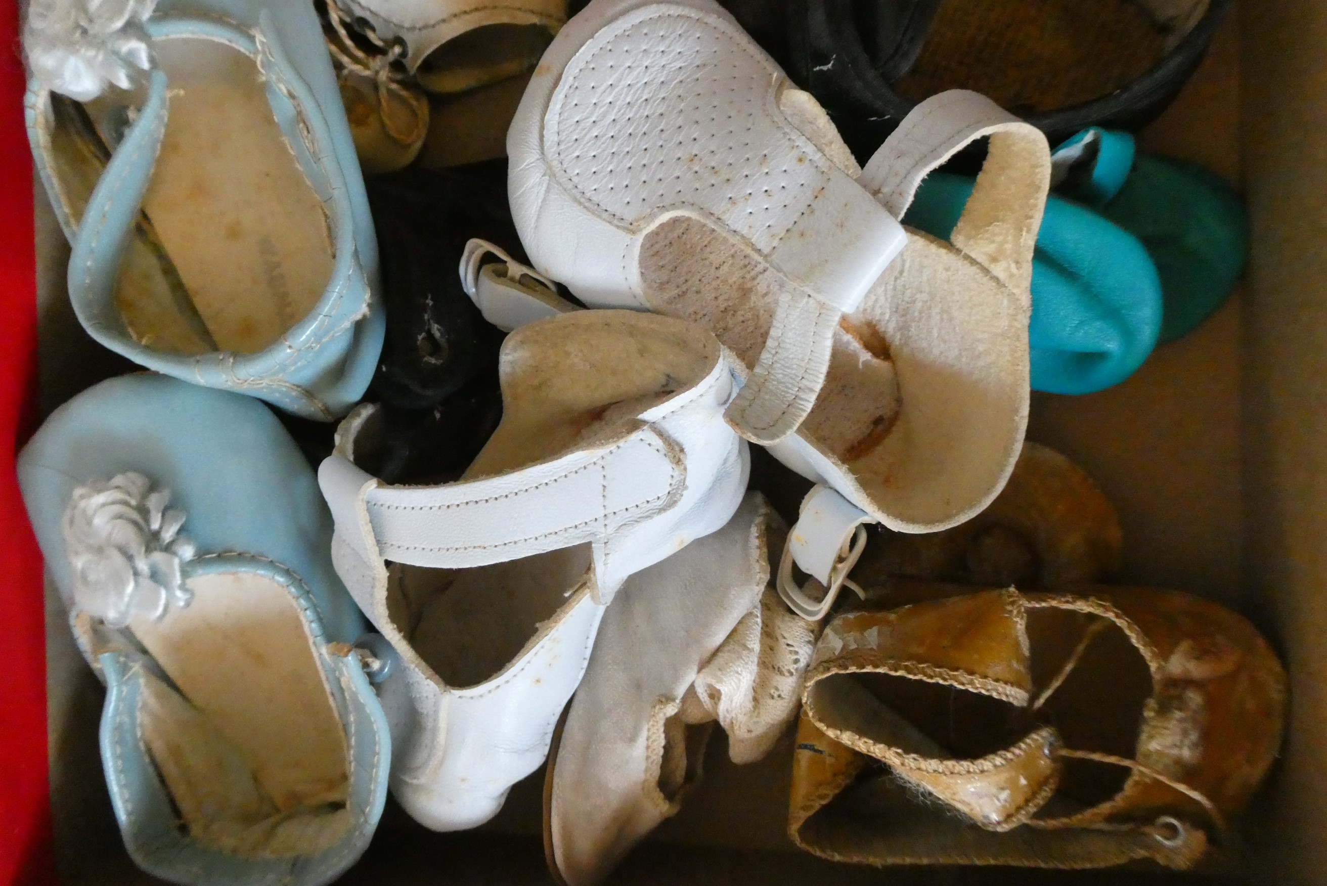 A box of antique and vintage dolls accessories including shoes, socks and glass eyes (Est. plus 24% Image