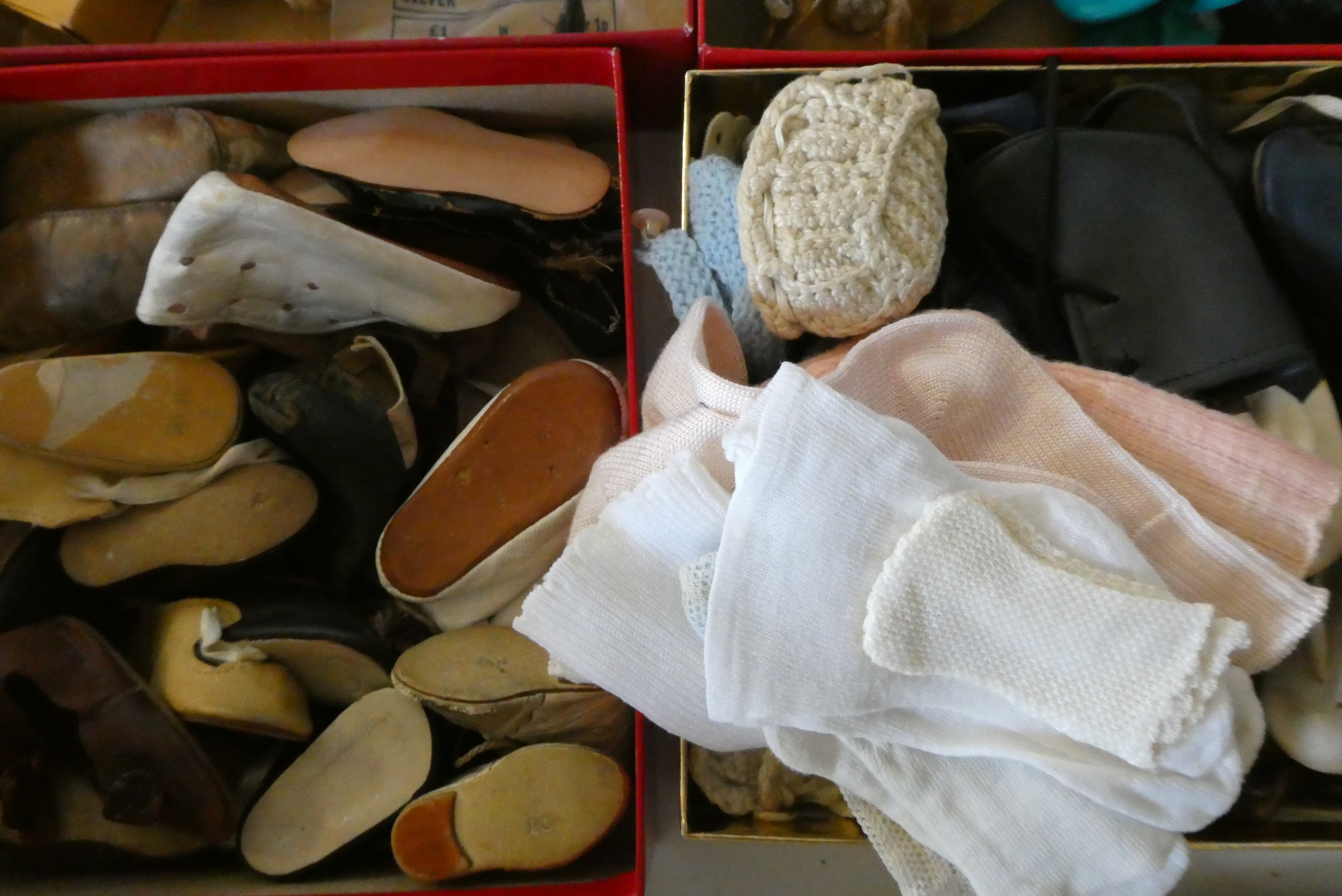 A box of antique and vintage dolls accessories including shoes, socks and glass eyes (Est. plus 24% Image