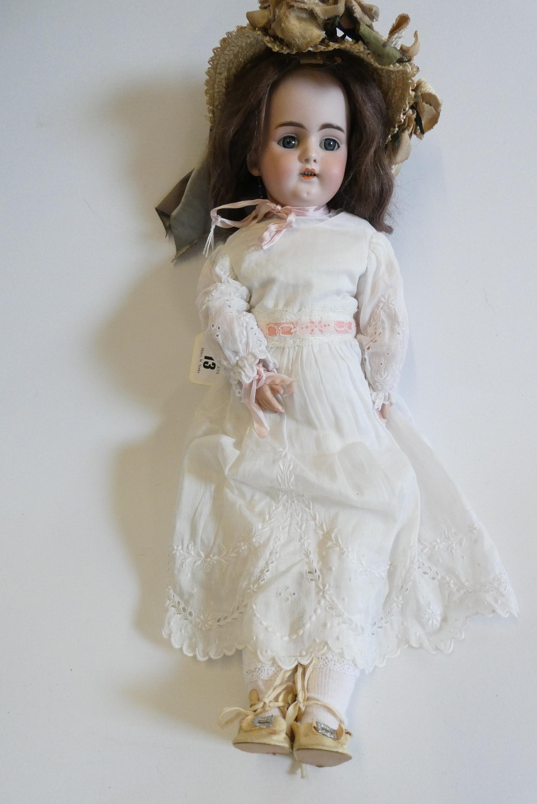 A Simon & Halbig bisque socket head doll with blue glass fixed eyes Image