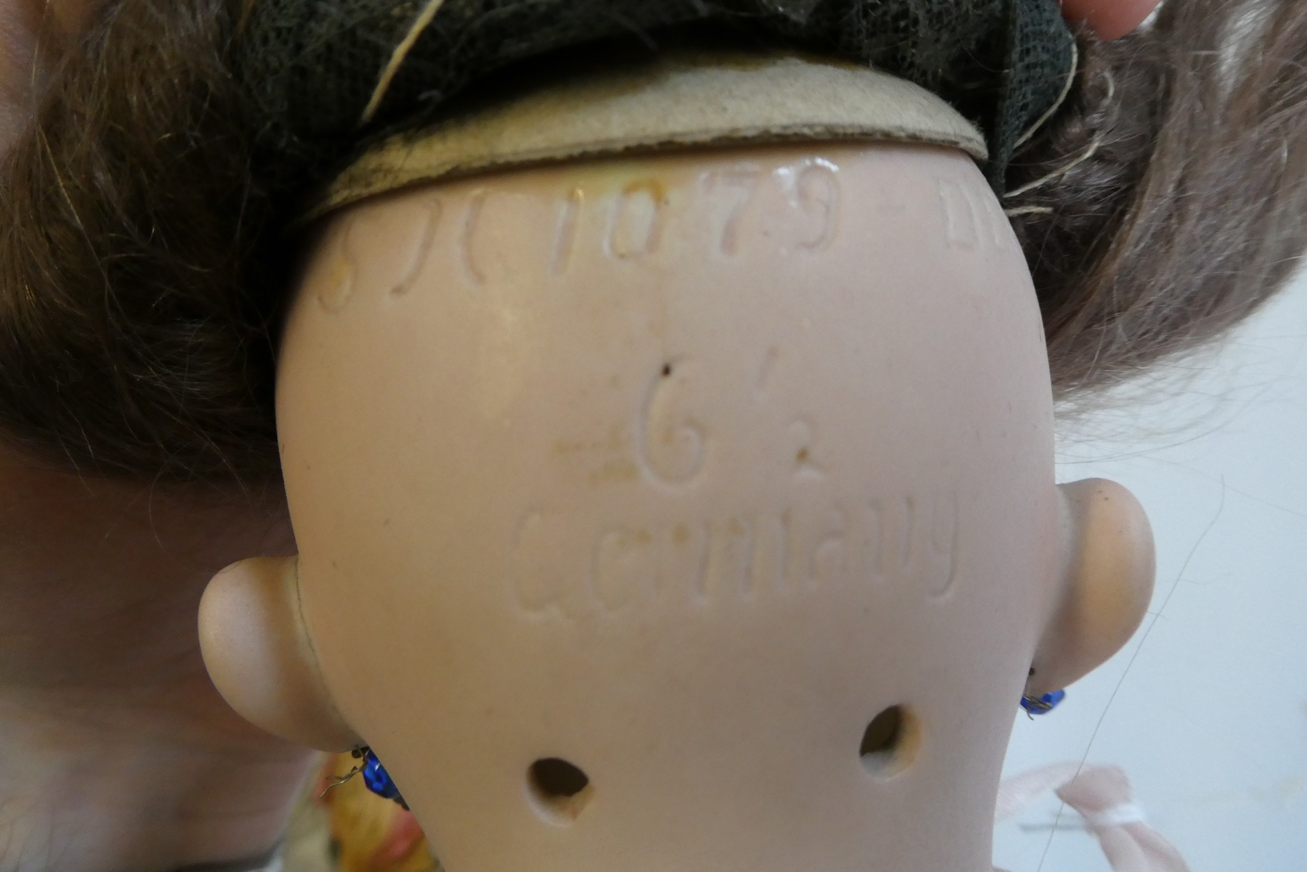 A Simon & Halbig bisque socket head doll with blue glass fixed eyes Image