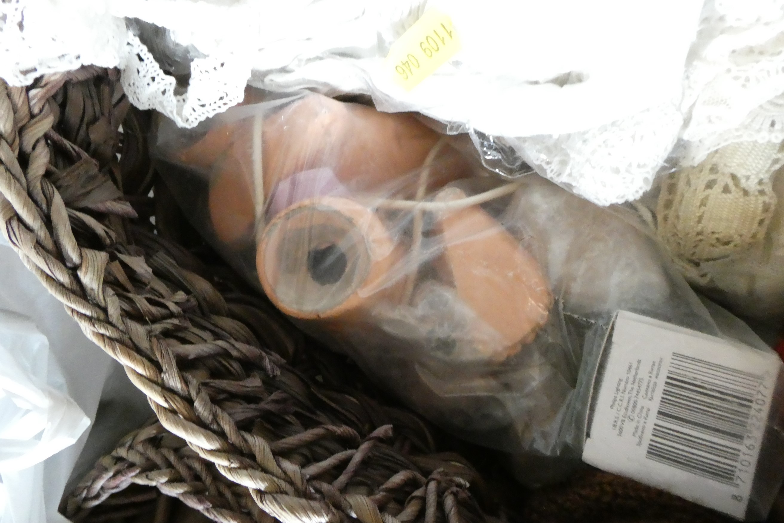 Two baskets of dolls clothing, spare parts and doll stands (Est. plus 24% premium inc. VAT) Image