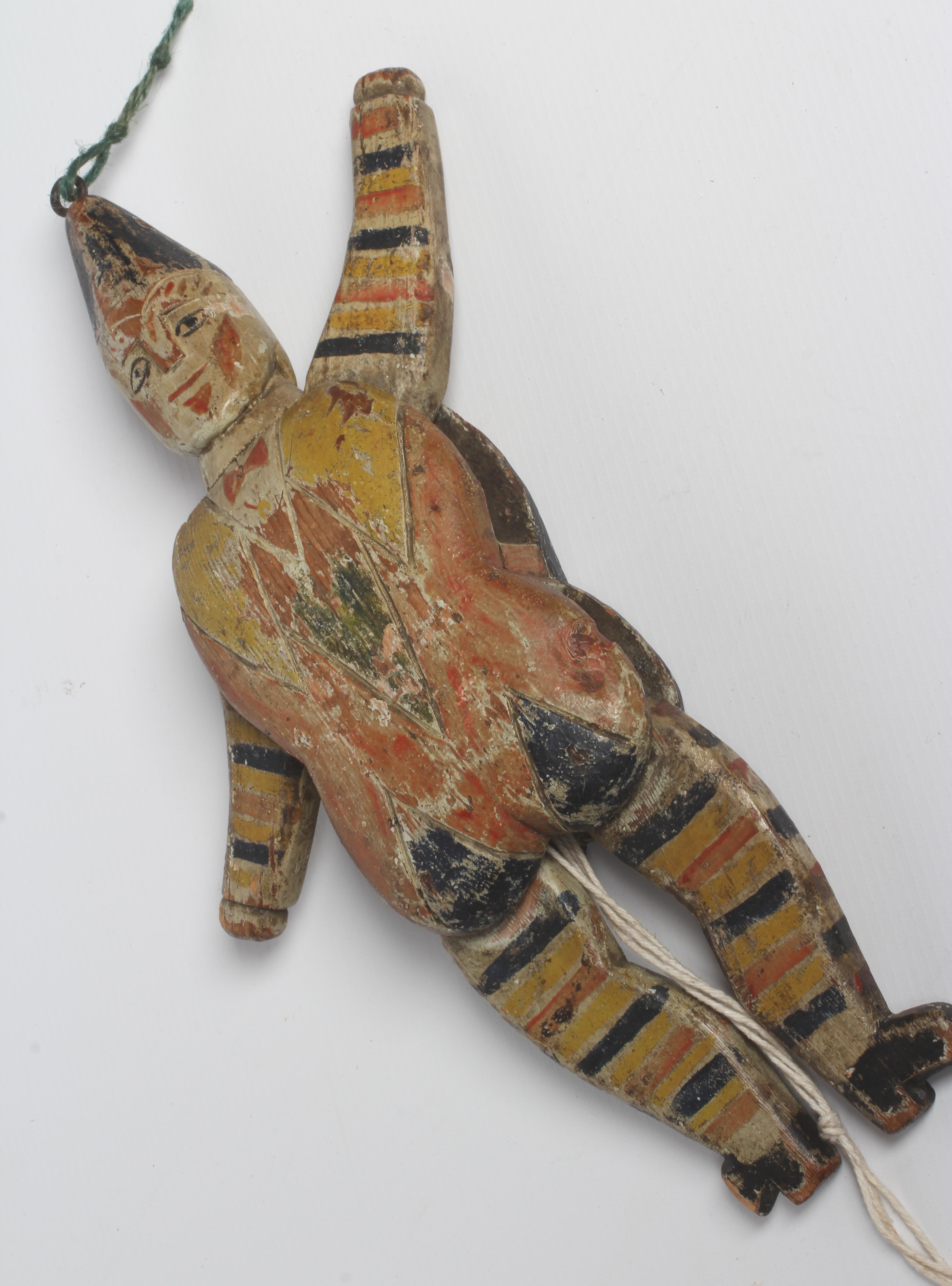 A folk art carved and painted wood jumping jack, double sided and with hinged shoulders and hips, 14 Image