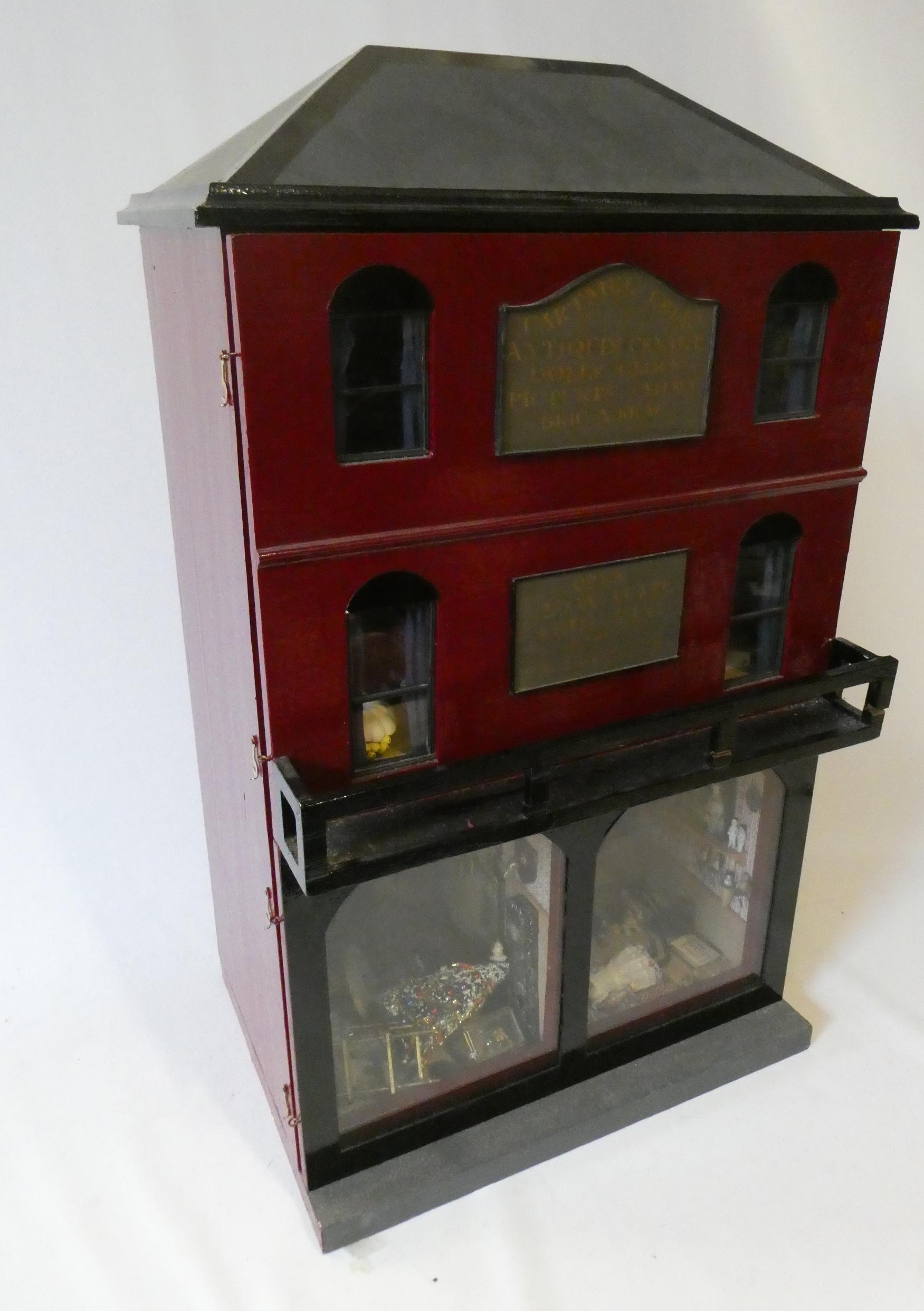 A doll's house and contents fitted as an antiques centre Image
