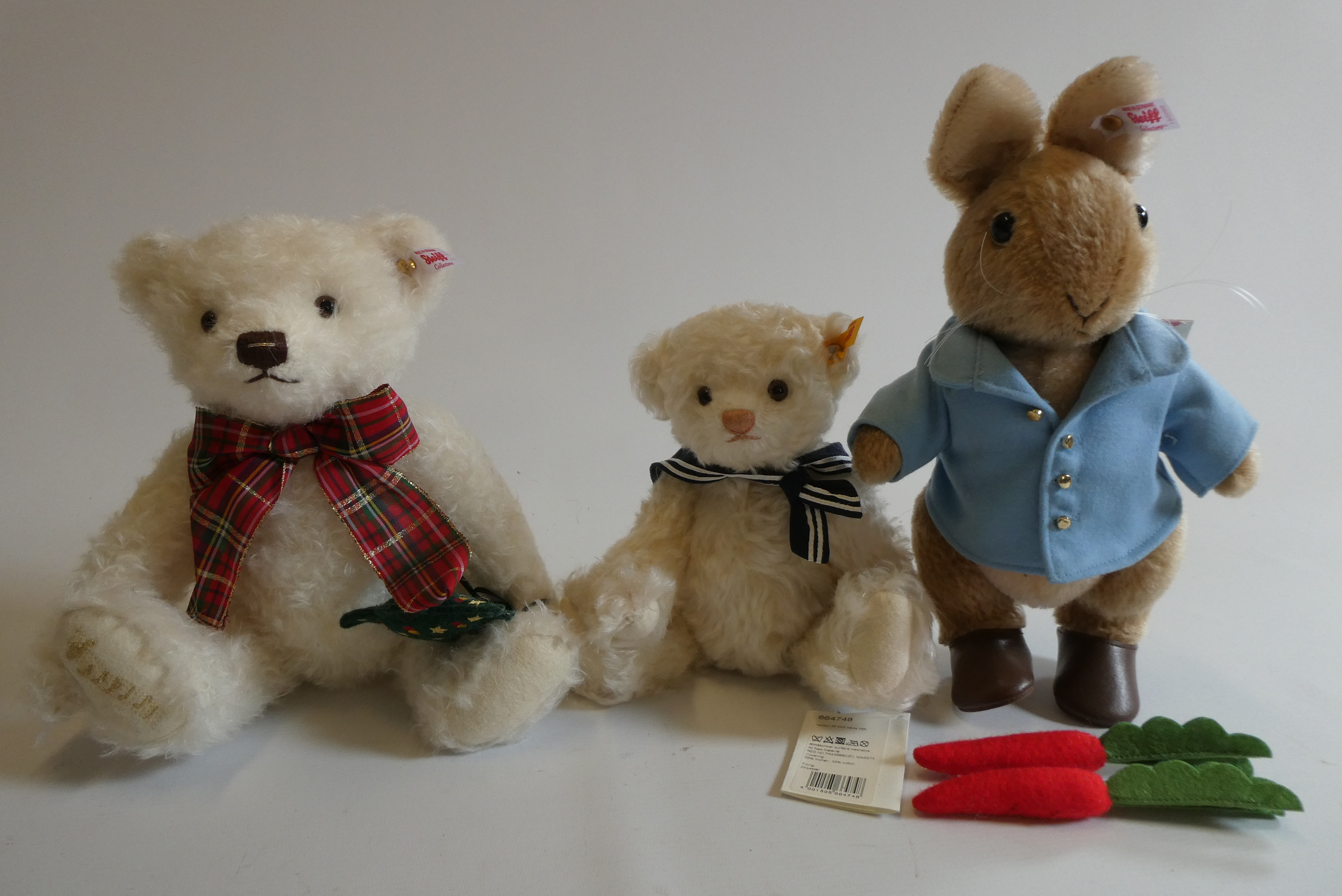Three Steiff bears, comprising a 12 1/2" Peter Rabbit with two carrots, 12 1/2" white Christmas bear Image
