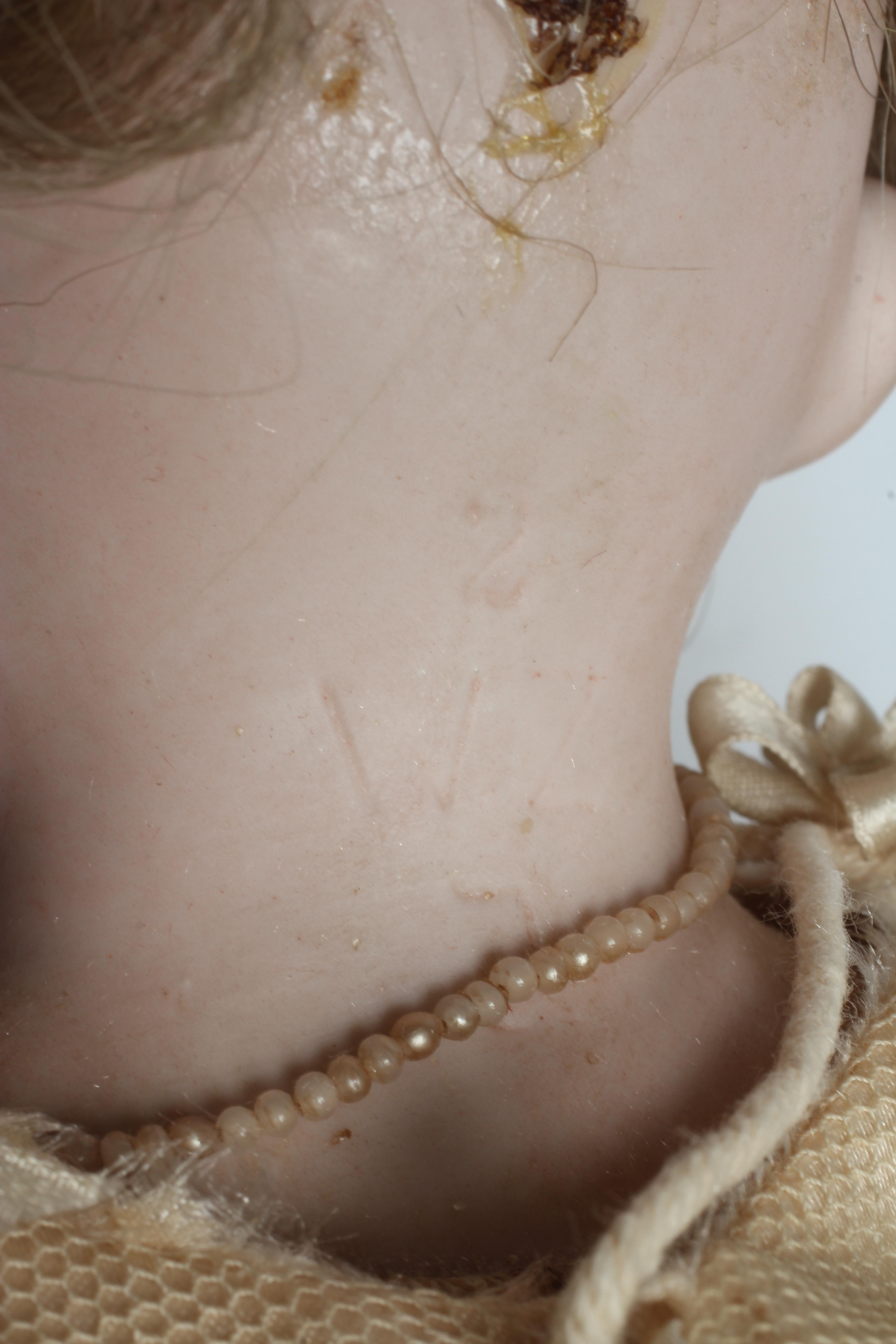 A Wagner & Zetsche bisque shoulder head doll with brown glass fixed eyes Image