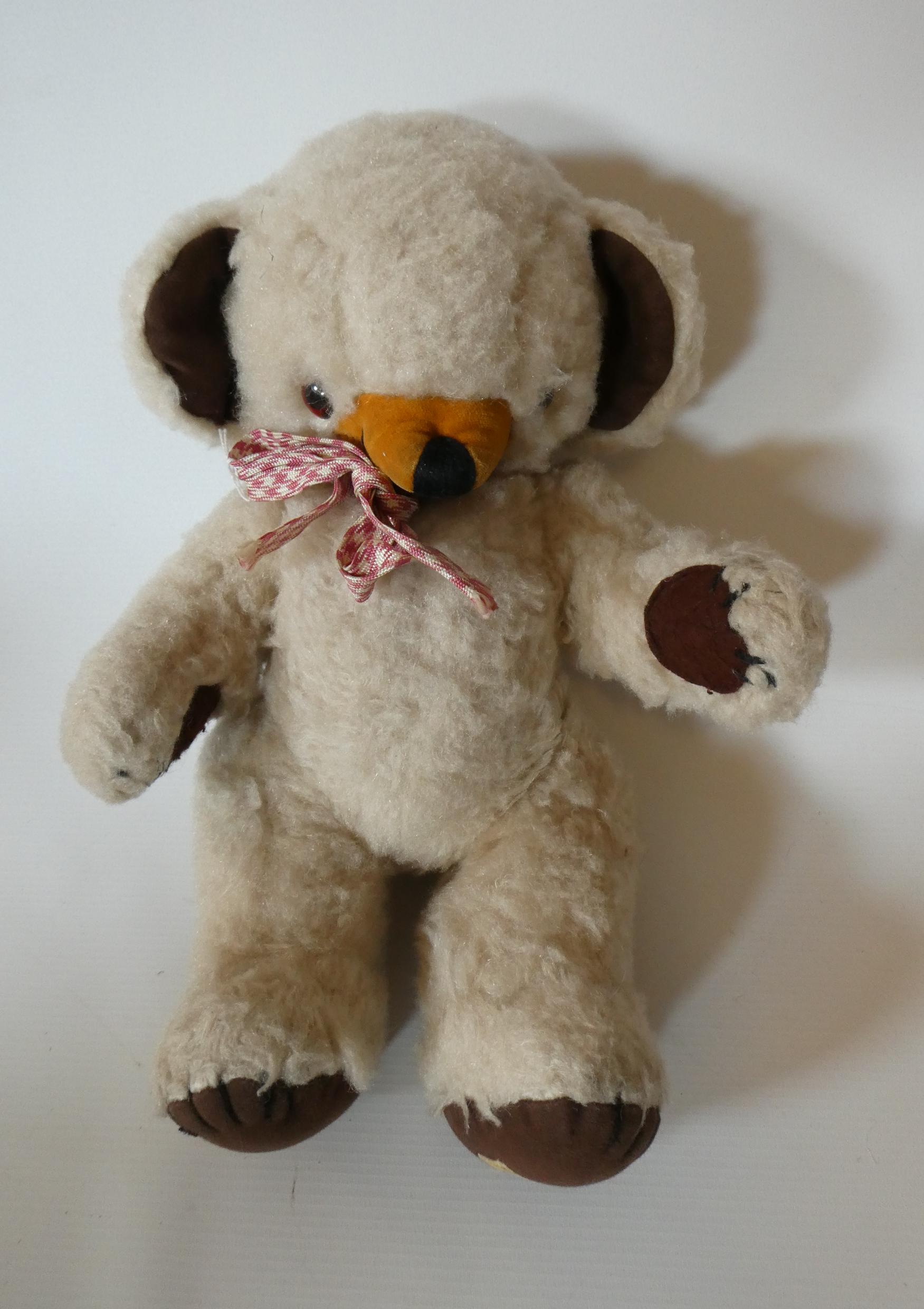 Merrythought jointed Cheeky Teddy Bear, with amber eyes, sewn nose, large ears with internal bells, Image