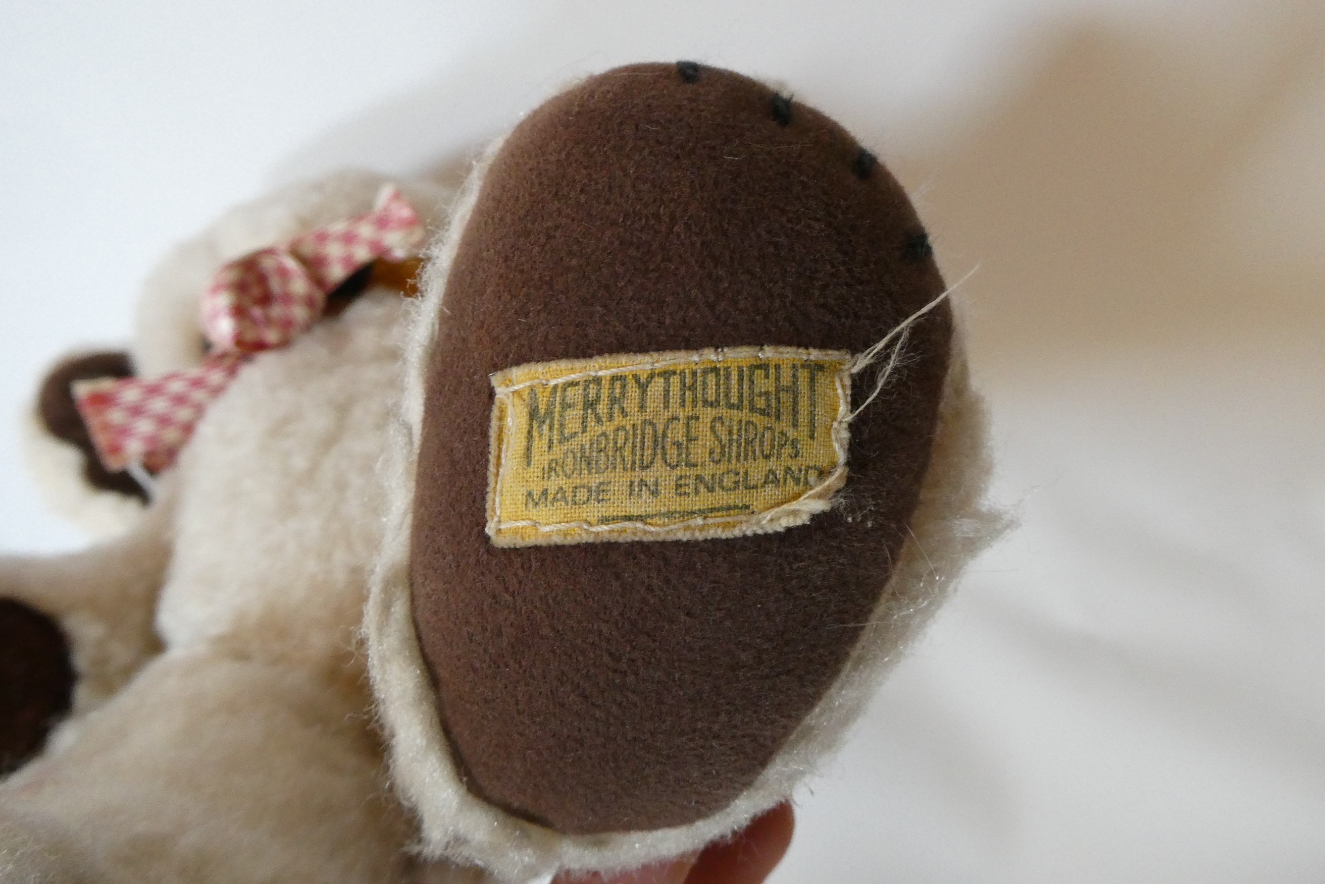 Merrythought jointed Cheeky Teddy Bear, with amber eyes, sewn nose, large ears with internal bells, Image