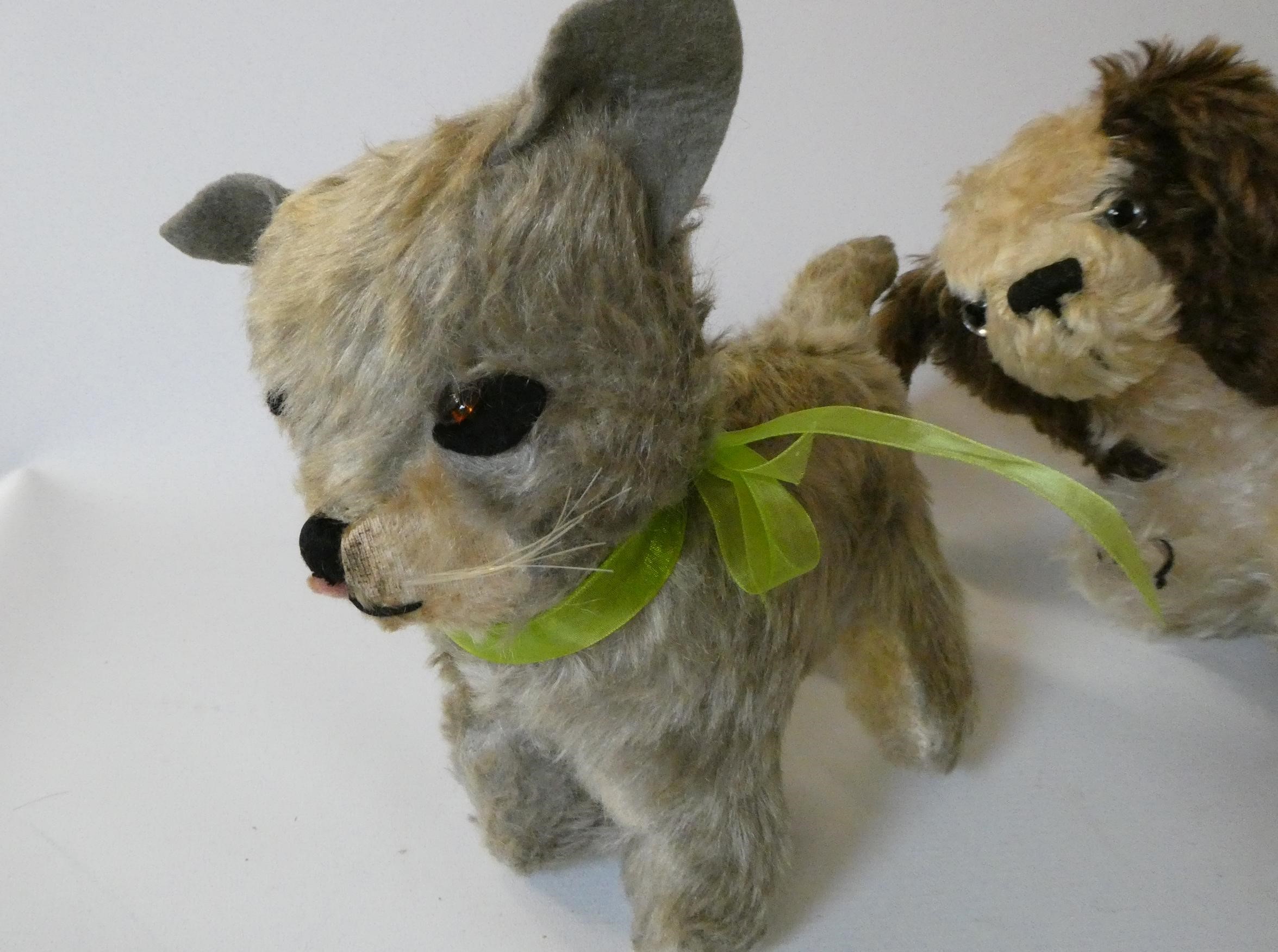 Three vintage plush toys, comprising a Chiltern cat with felt ears and tongue, a puppy pyjama case Image