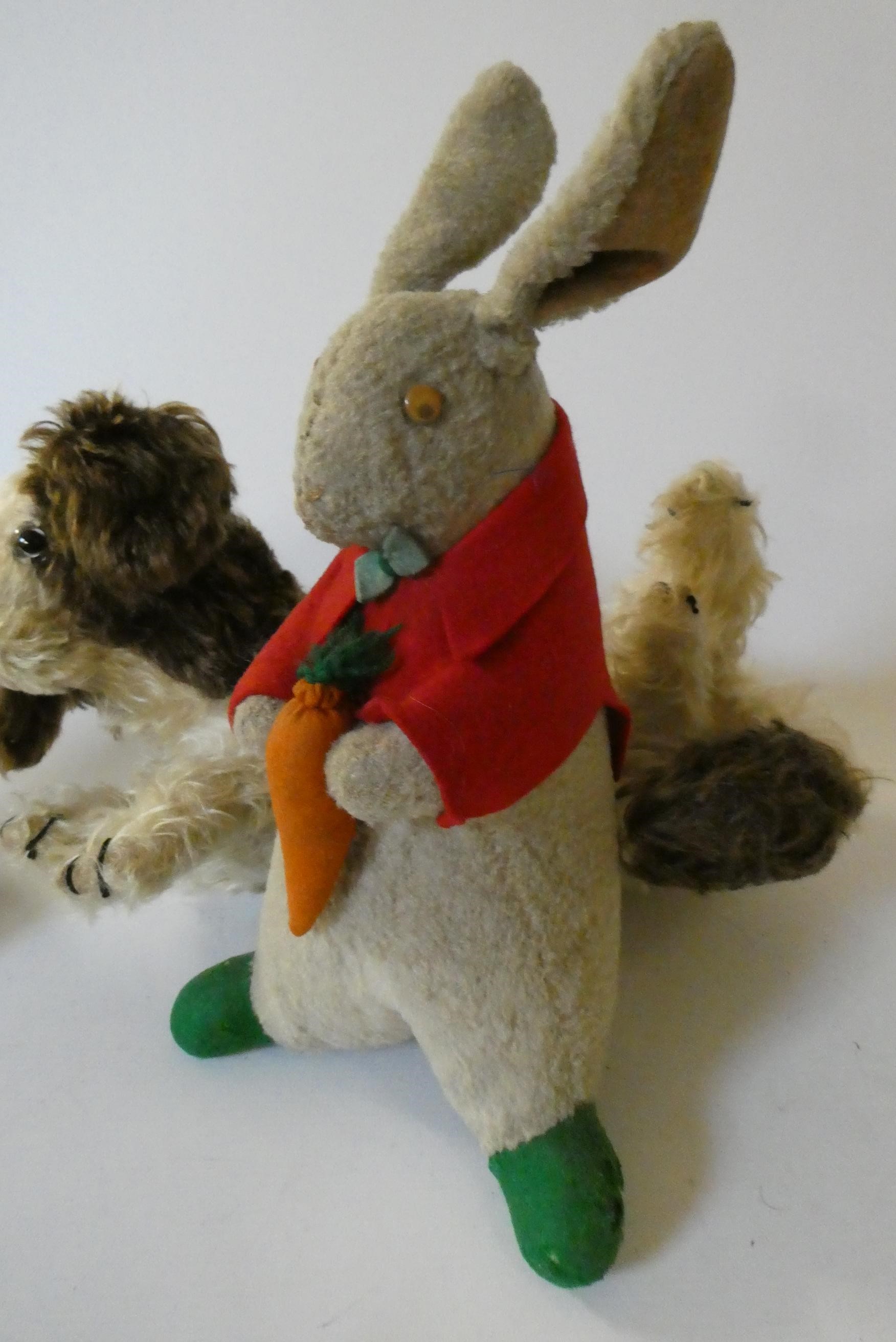 Three vintage plush toys, comprising a Chiltern cat with felt ears and tongue, a puppy pyjama case Image