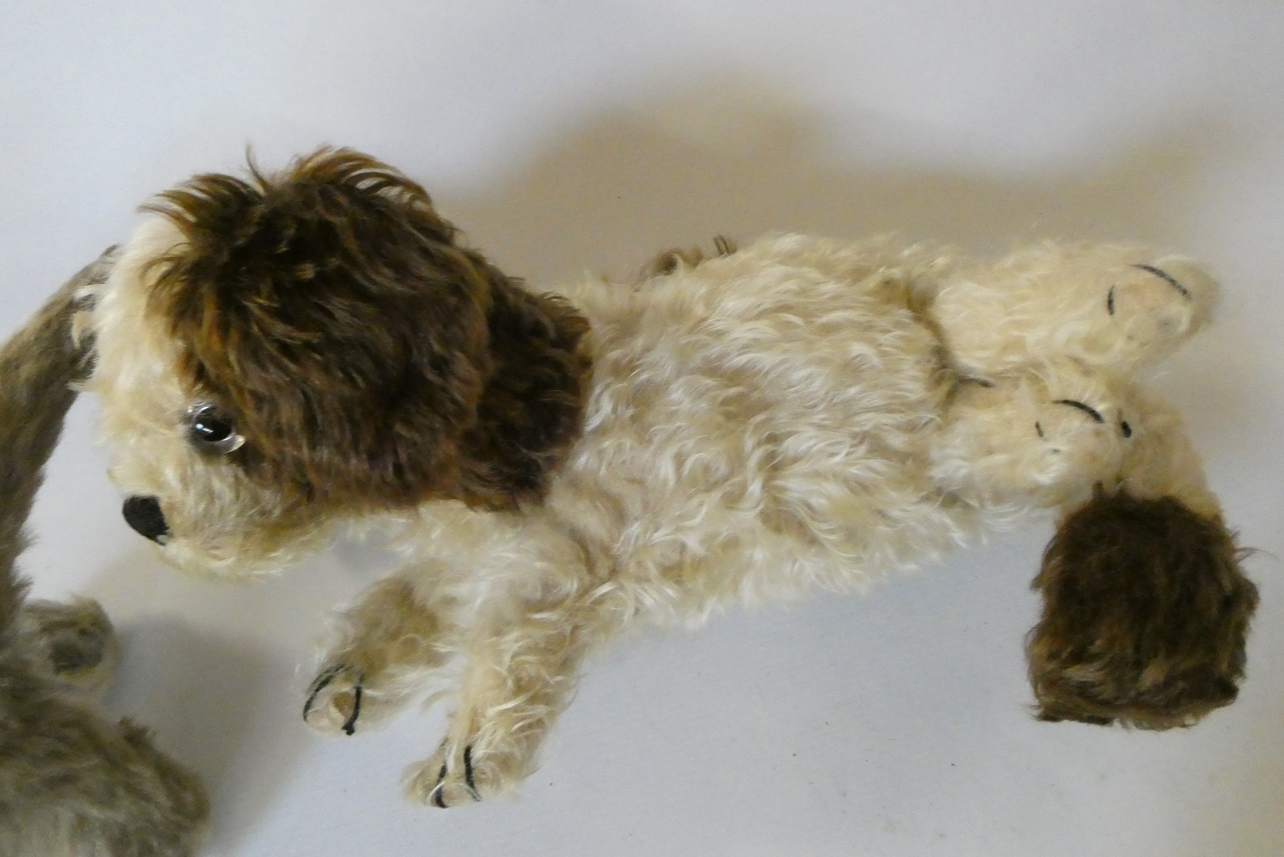 Three vintage plush toys, comprising a Chiltern cat with felt ears and tongue, a puppy pyjama case Image
