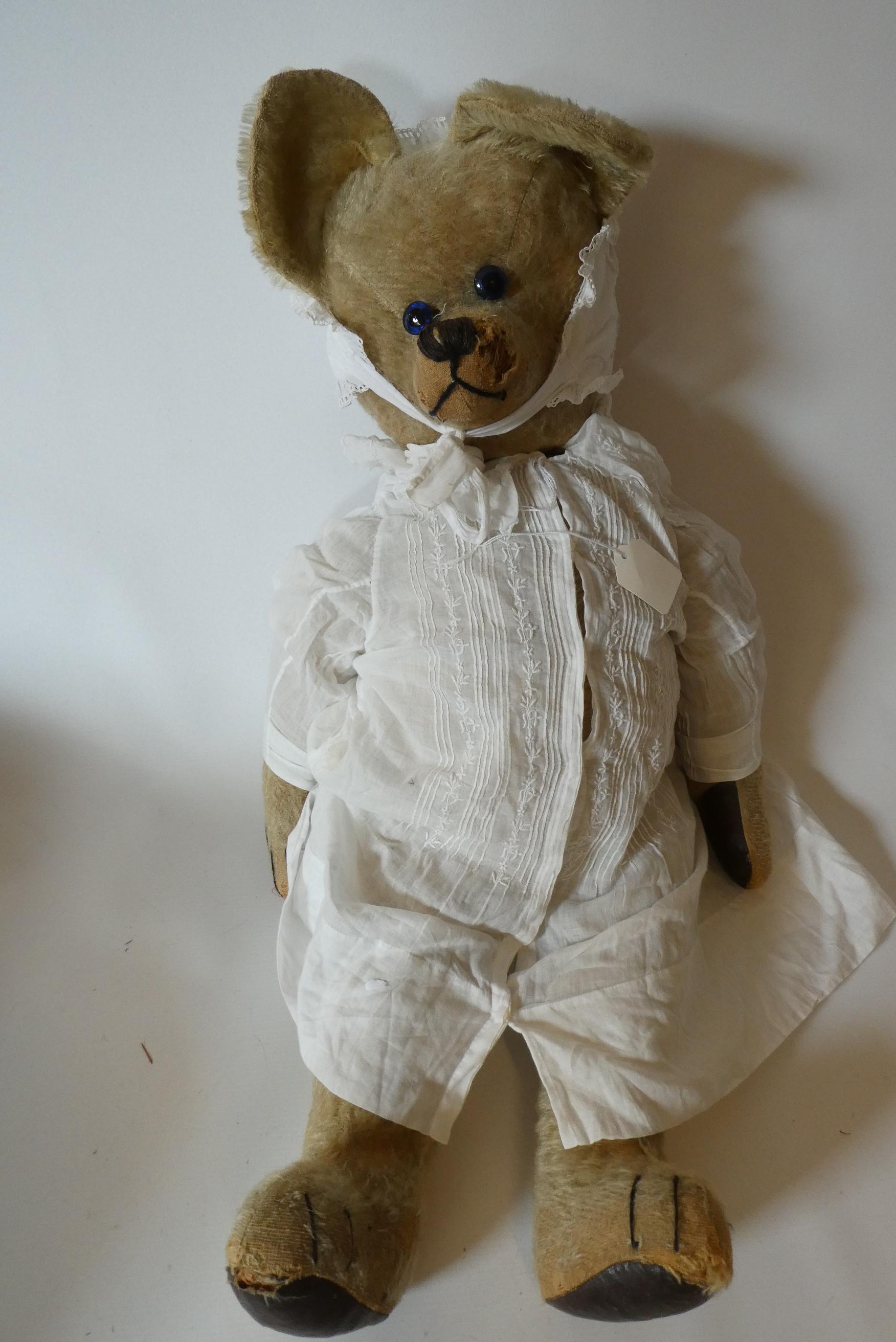 A large straw filled jointed "Tilly Ted" teddy bear, with blue glass eyes, long nose, large ears, Image