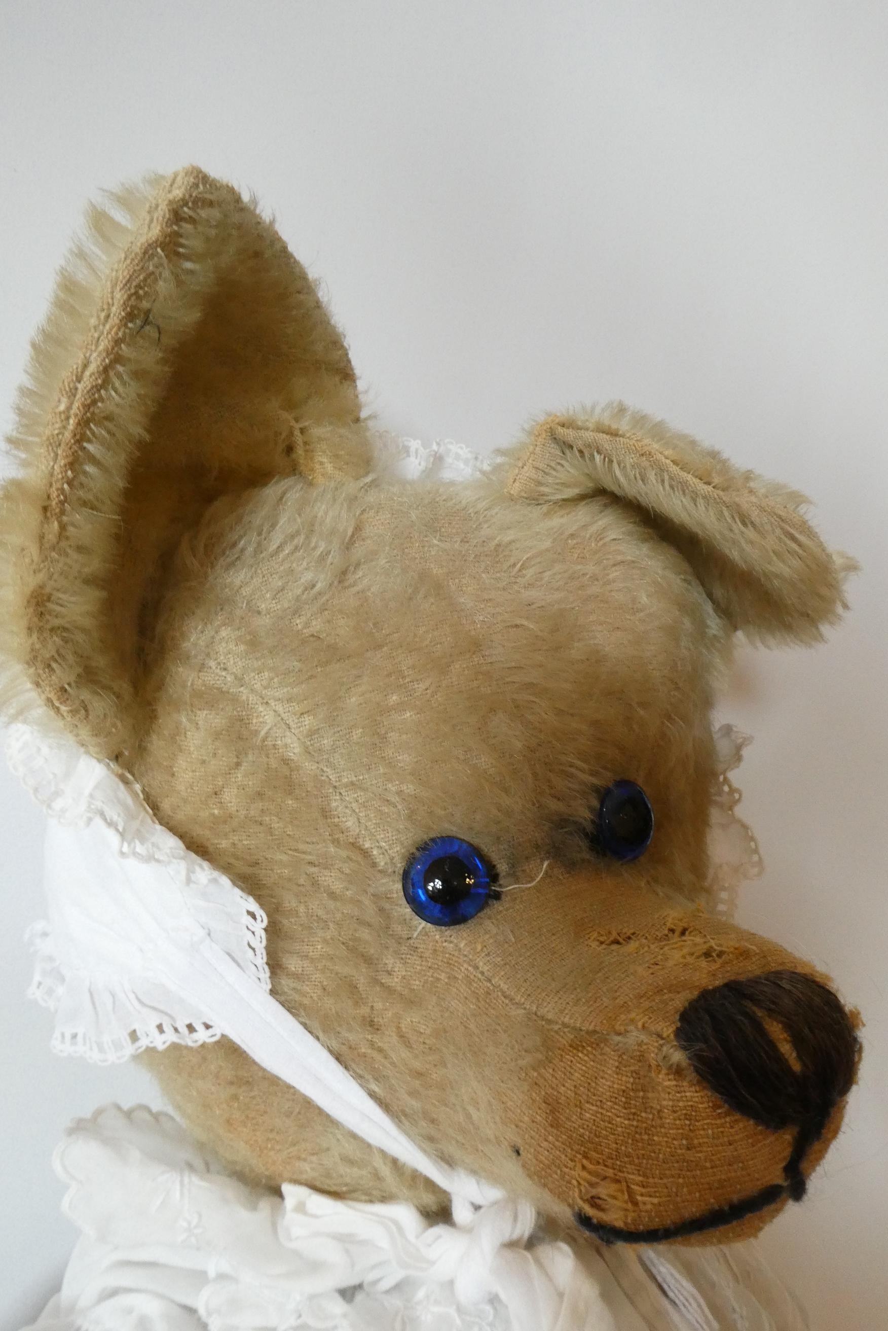 A large straw filled jointed "Tilly Ted" teddy bear, with blue glass eyes, long nose, large ears, Image