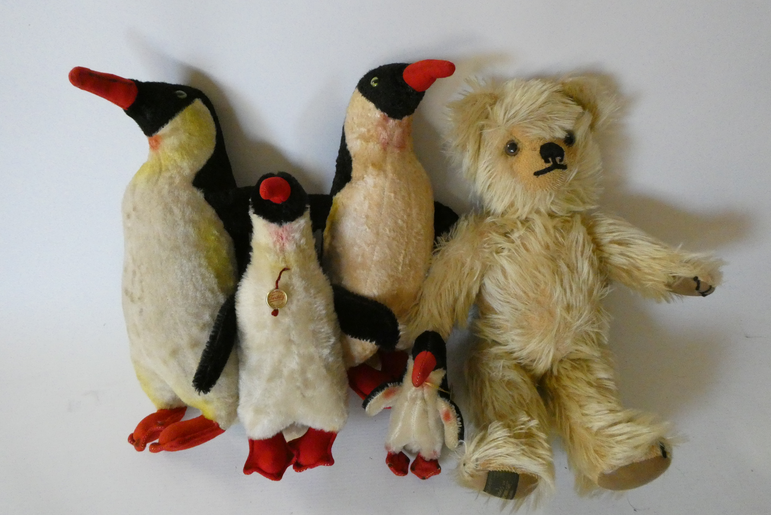 A family of Hermann Penguins, mum, dad, teenager and chick, two with original labels and all with Image