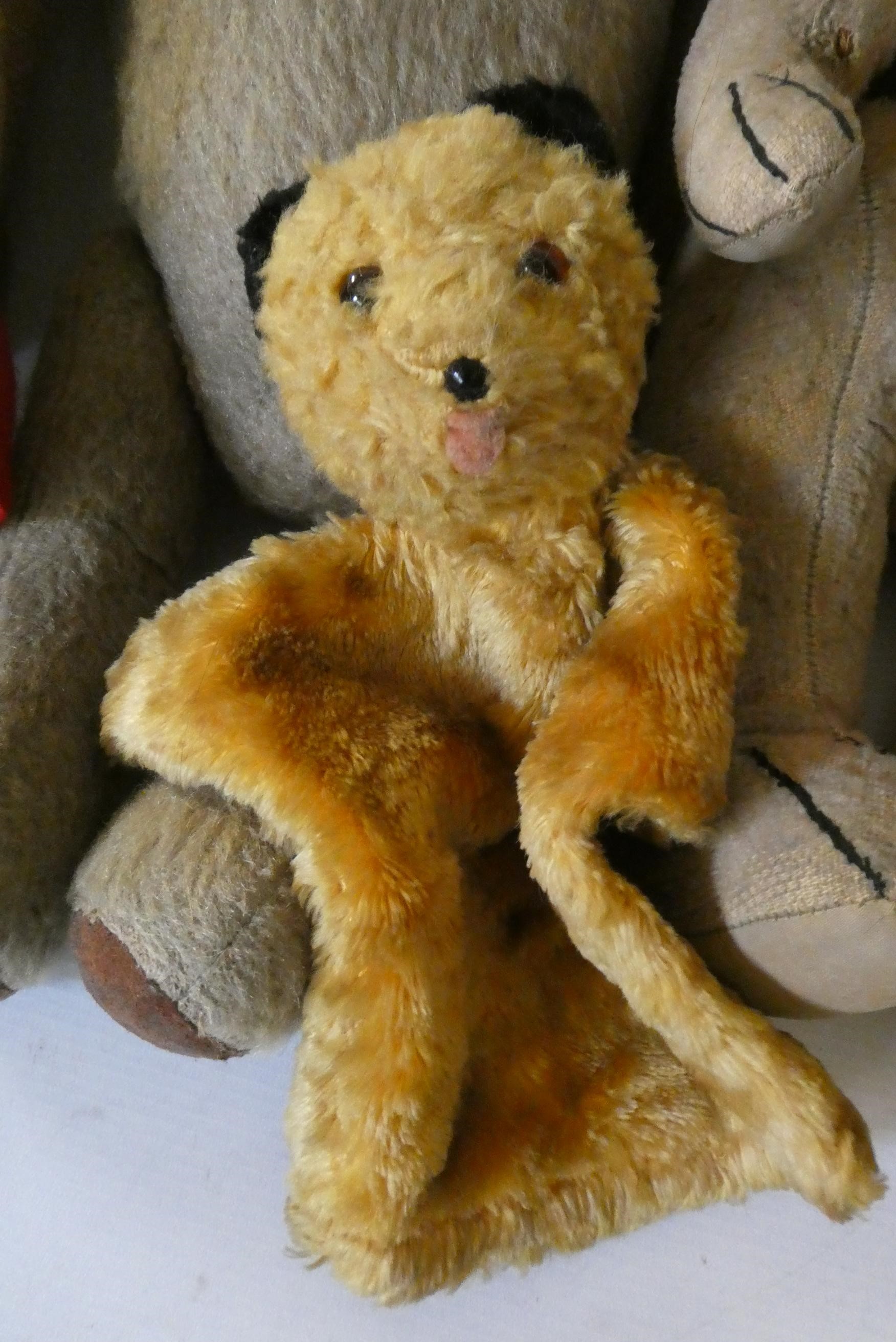 Seven vintage plush toys comprising three large teddy bears, one small soldier bear, two puppets Image