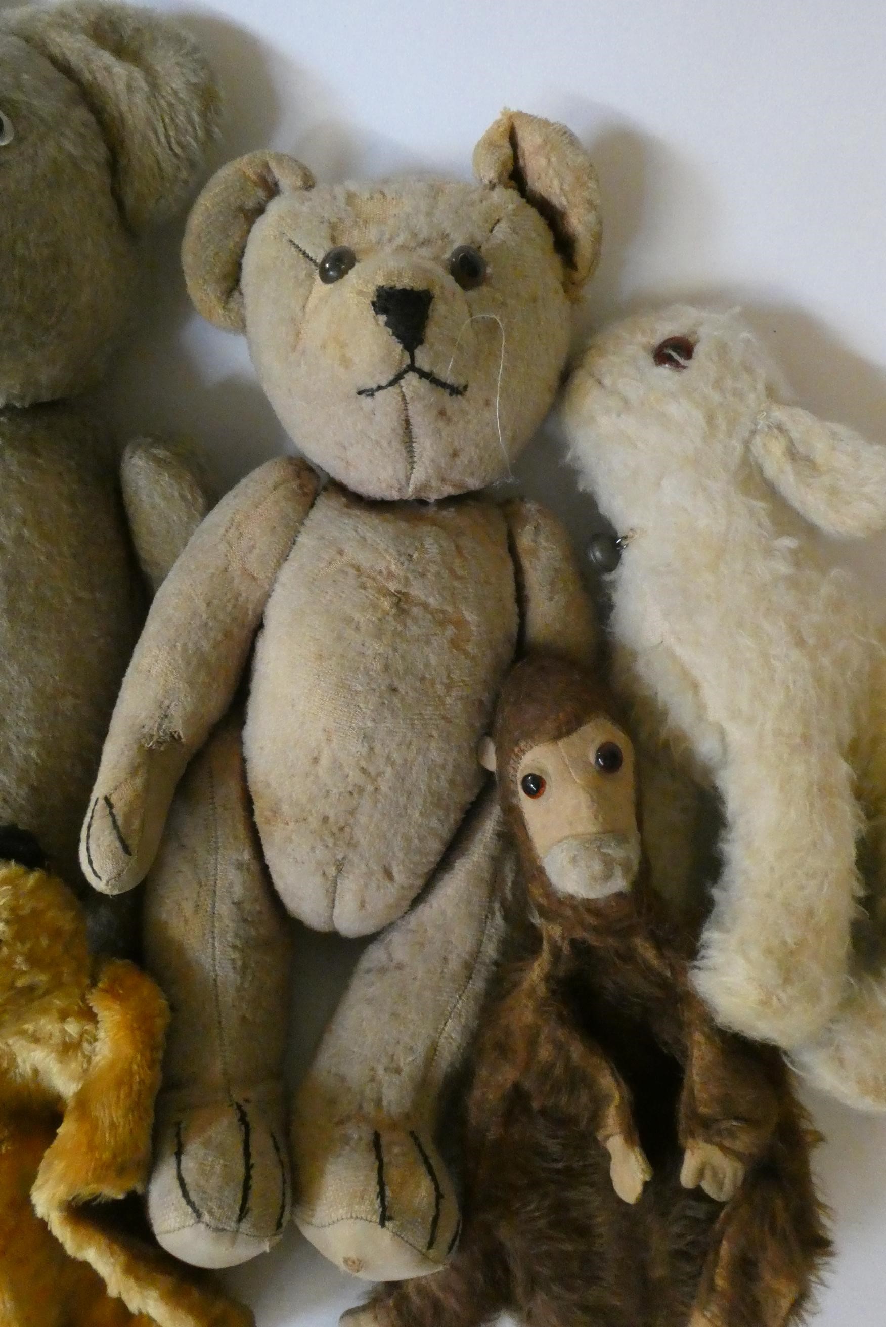 Seven vintage plush toys comprising three large teddy bears, one small soldier bear, two puppets Image