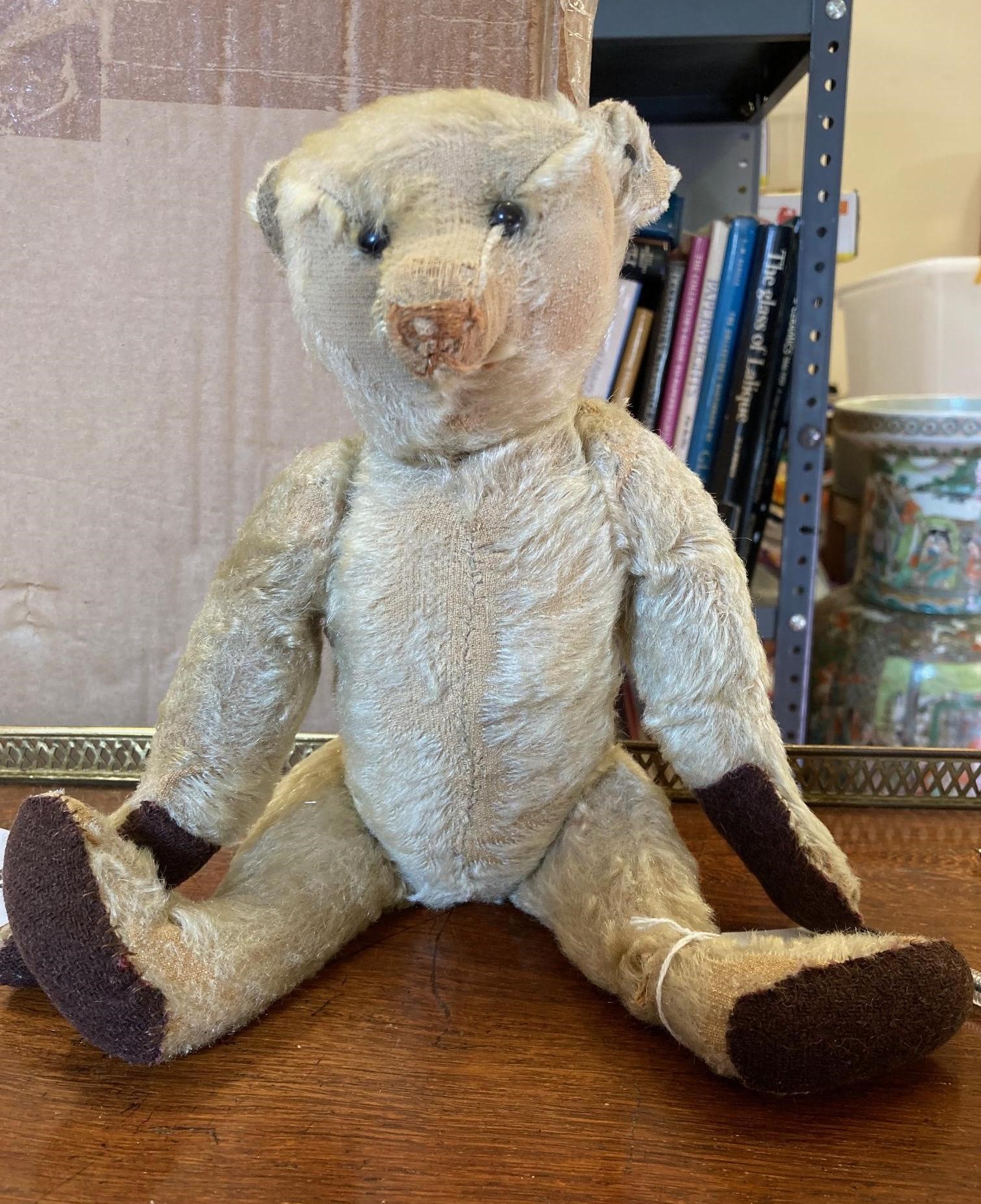 An early 20th century Steiff teddy bear with metal ear button, black shoe button eyes, light orange Image