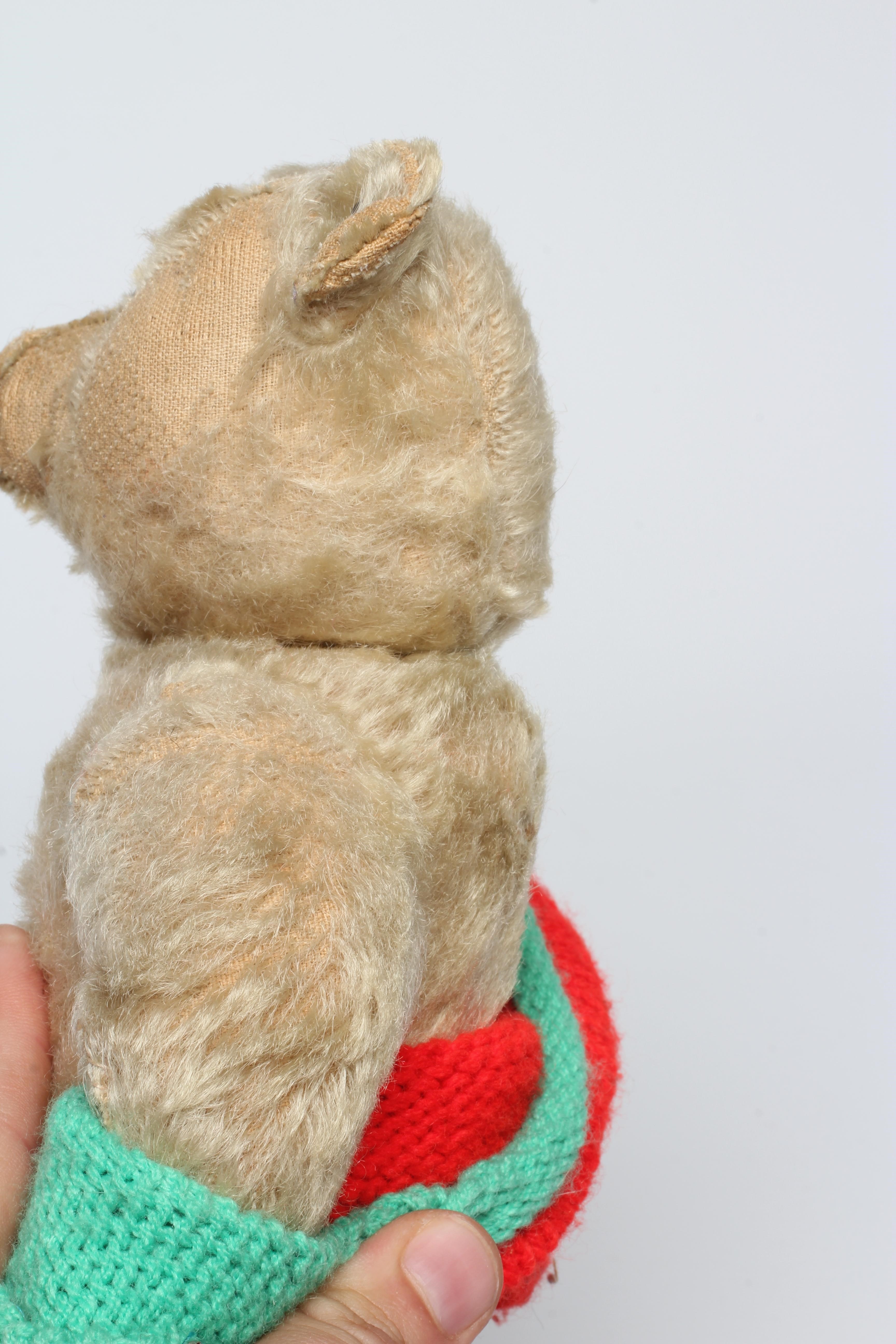 An early 20th century Steiff teddy bear with metal ear button, black shoe button eyes, light orange Image