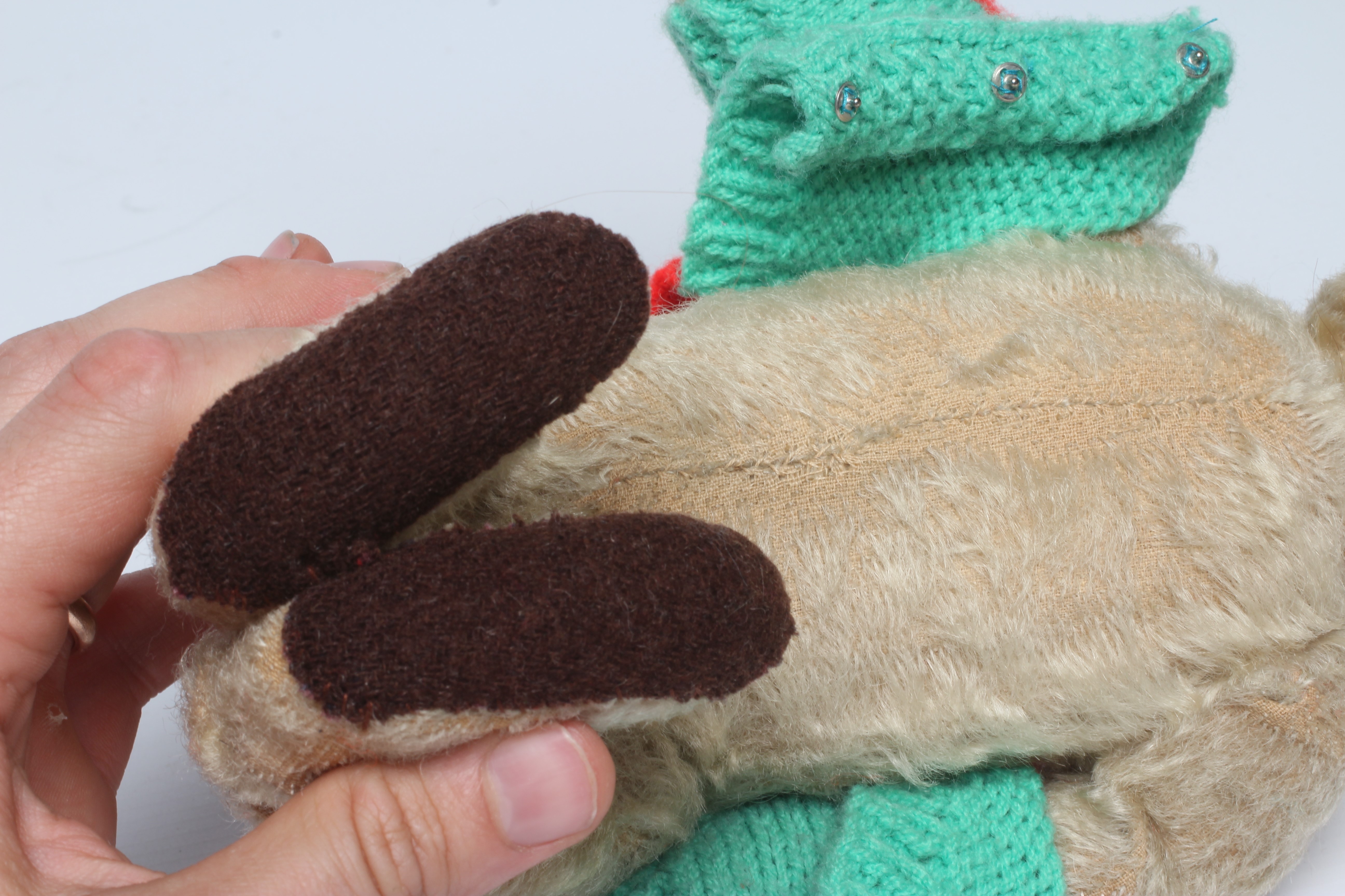 An early 20th century Steiff teddy bear with metal ear button, black shoe button eyes, light orange Image