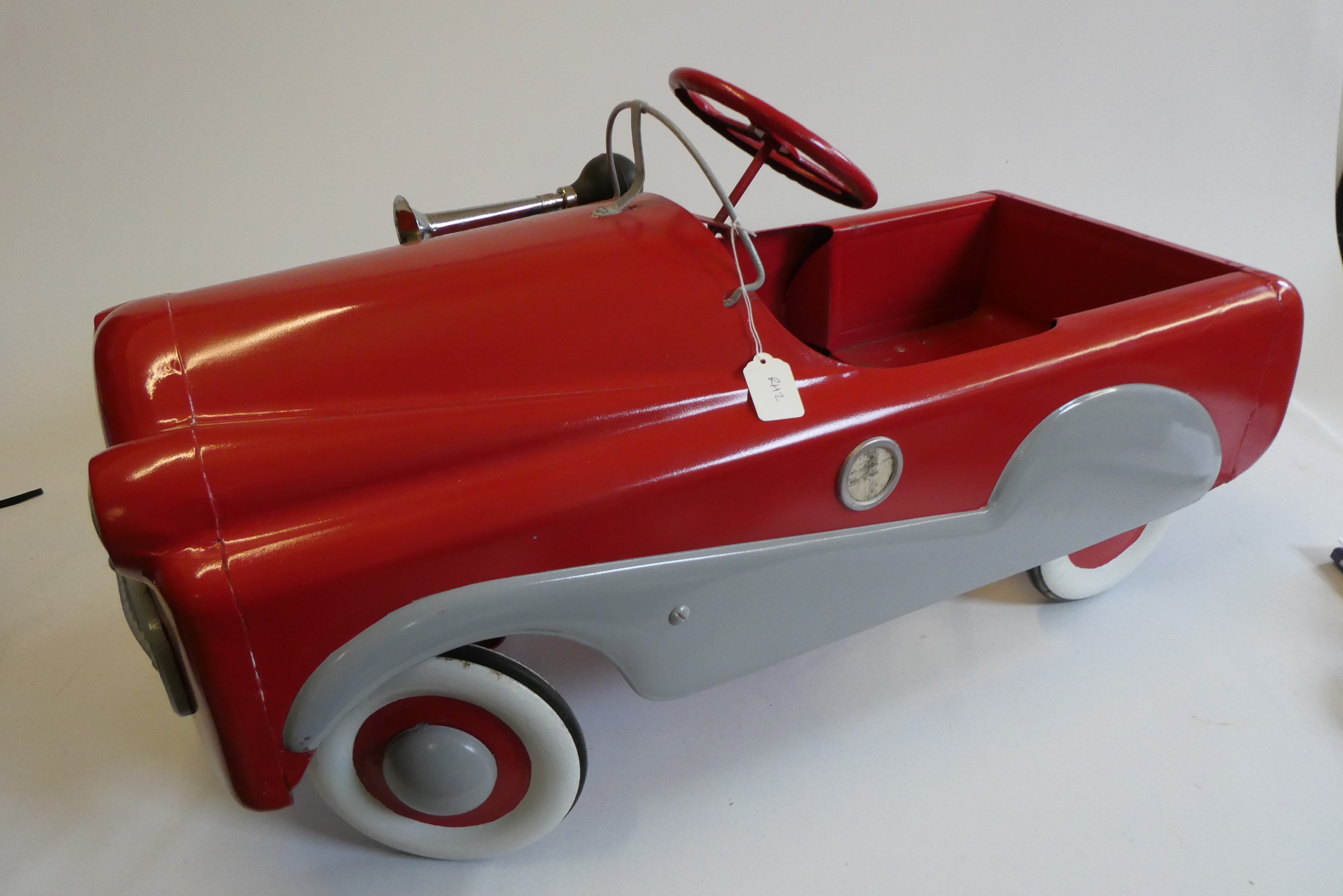 A Mobo pedal car, 1950s, with painted metal body, manual horn and wire windshield, 36" x 14 1/2", Image