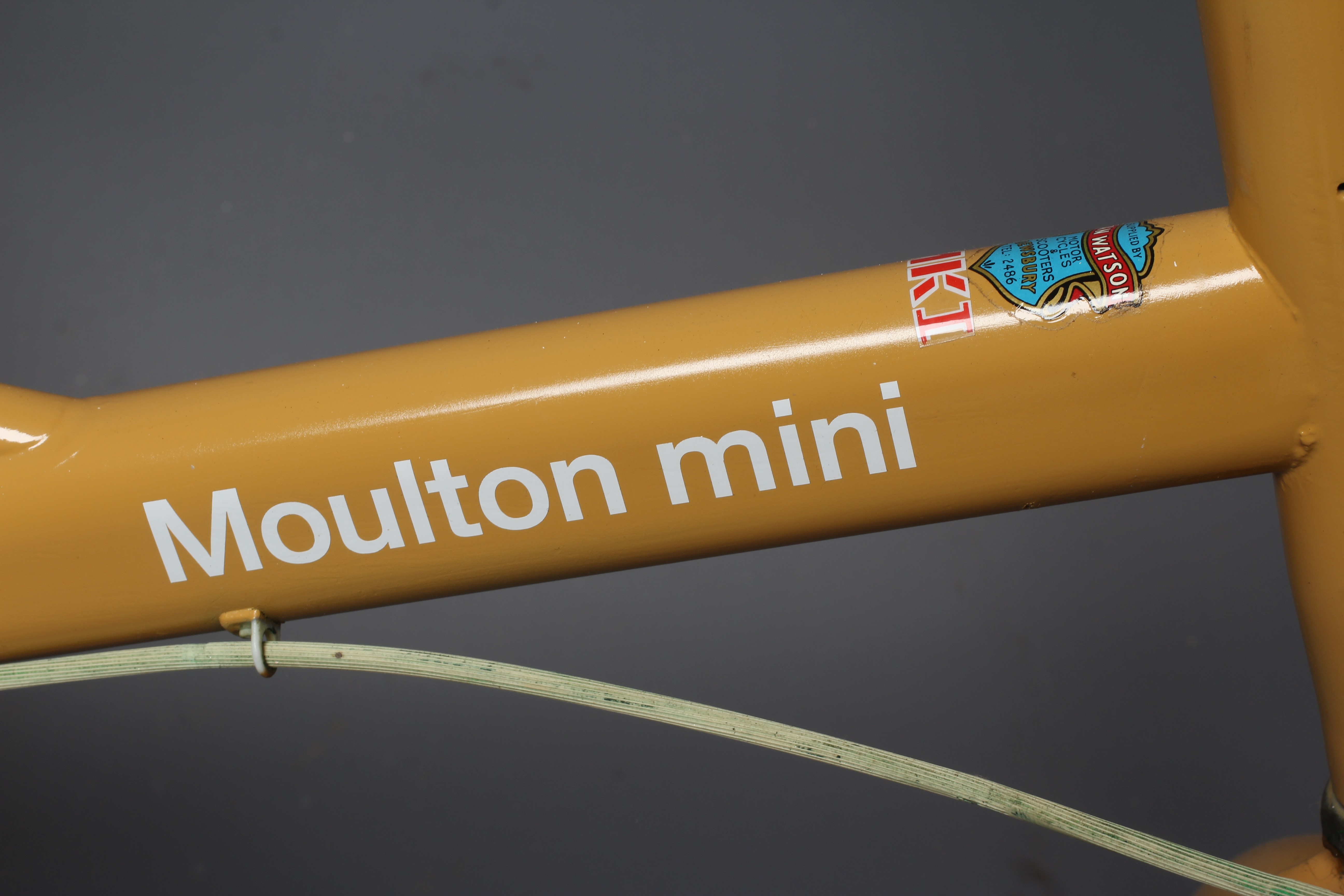 A Moulton Mini MKI shopper style unisex bike in brown, 14" wheels, with Alan Watson shop label, good Image