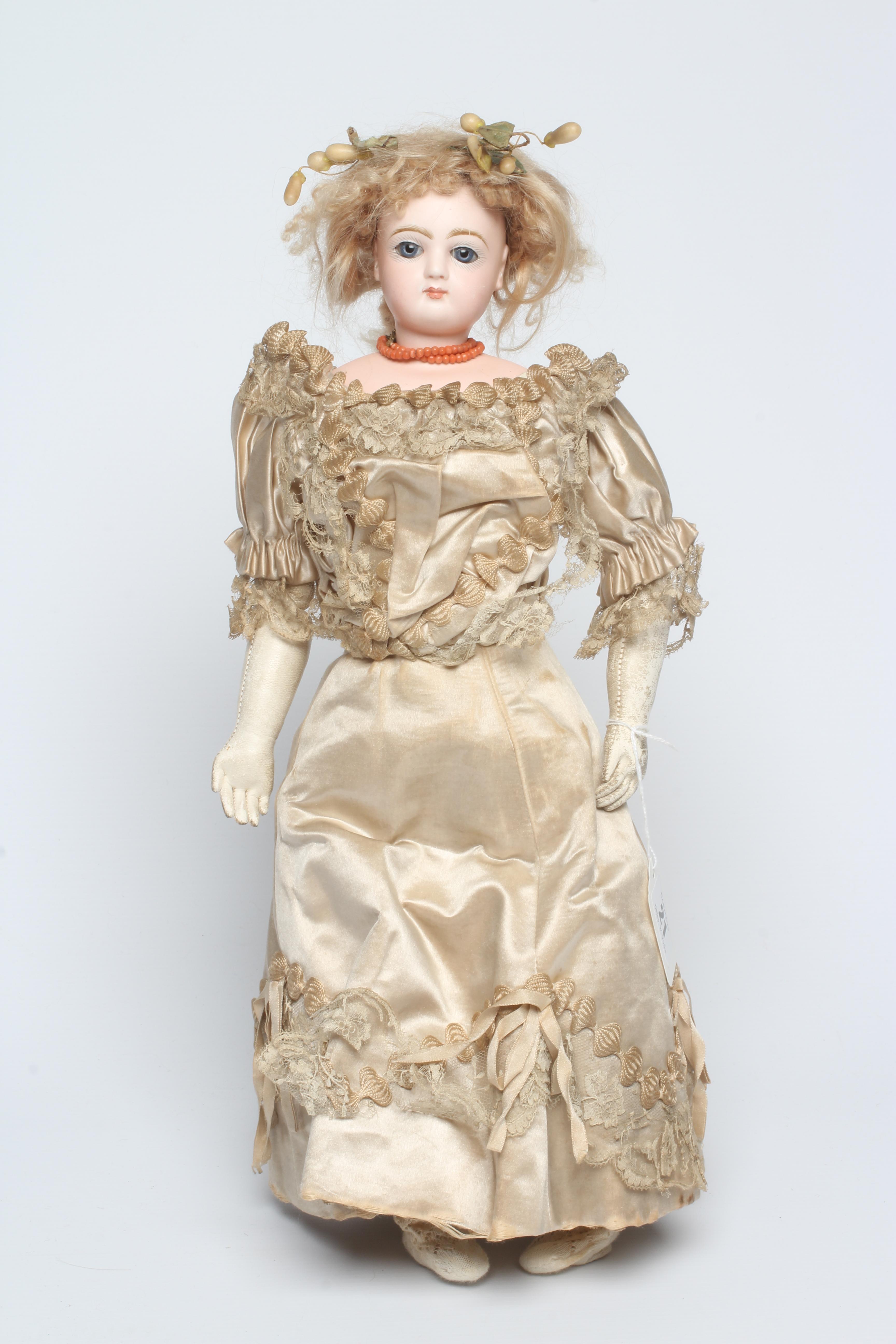 A Jumeau bisque shoulder head doll with blue glass fixed eyes Image