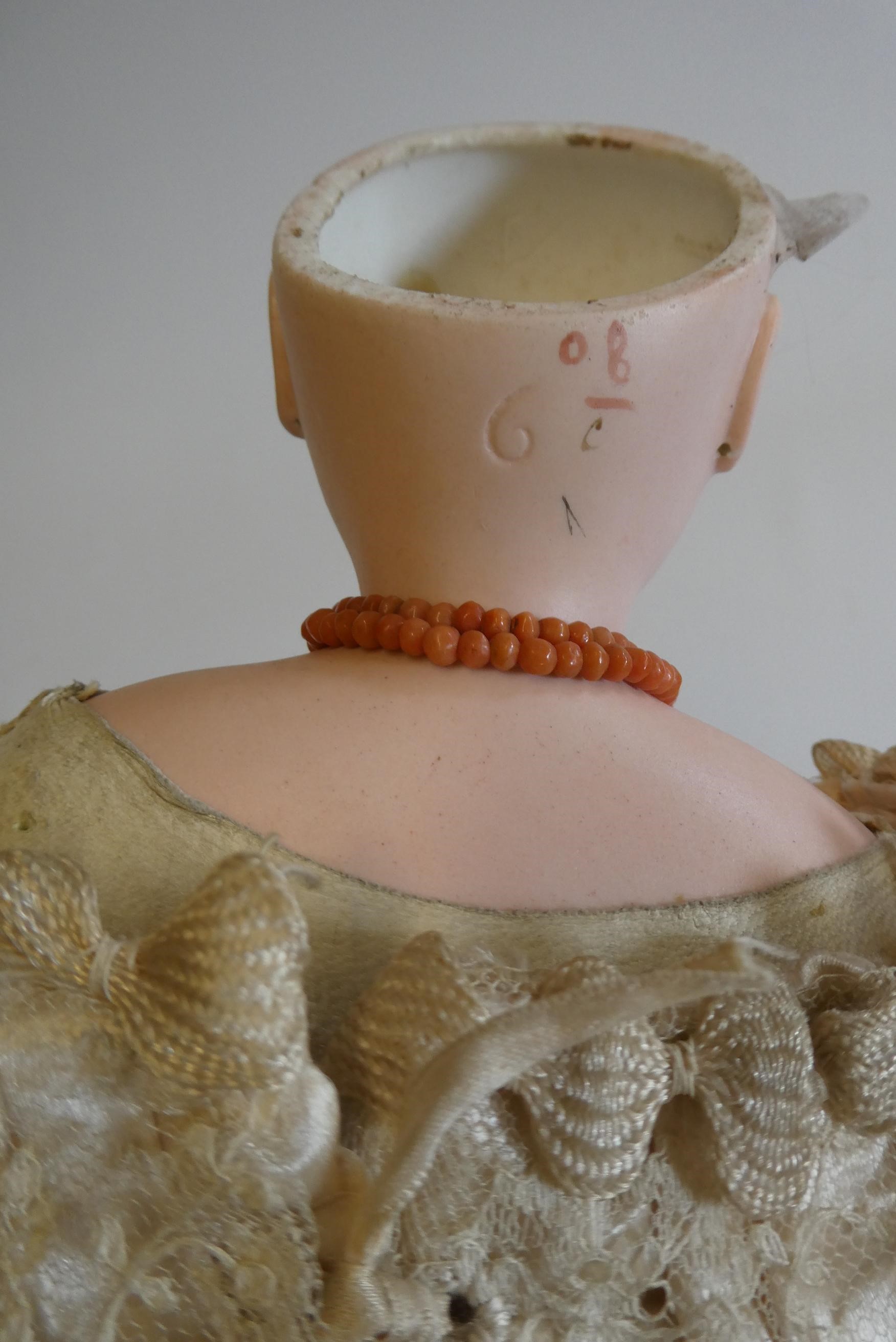 A Jumeau bisque shoulder head doll with blue glass fixed eyes Image