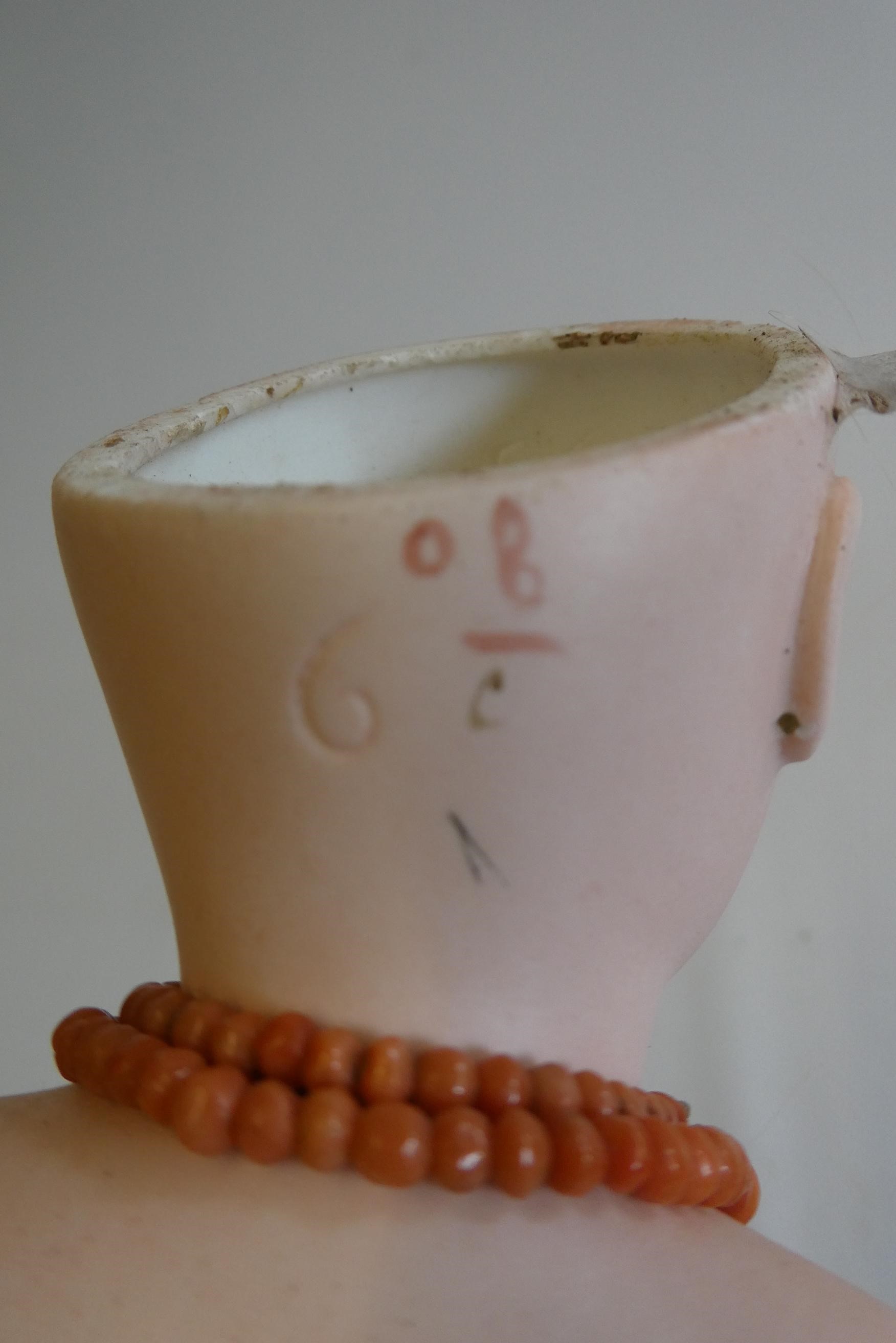 A Jumeau bisque shoulder head doll with blue glass fixed eyes Image