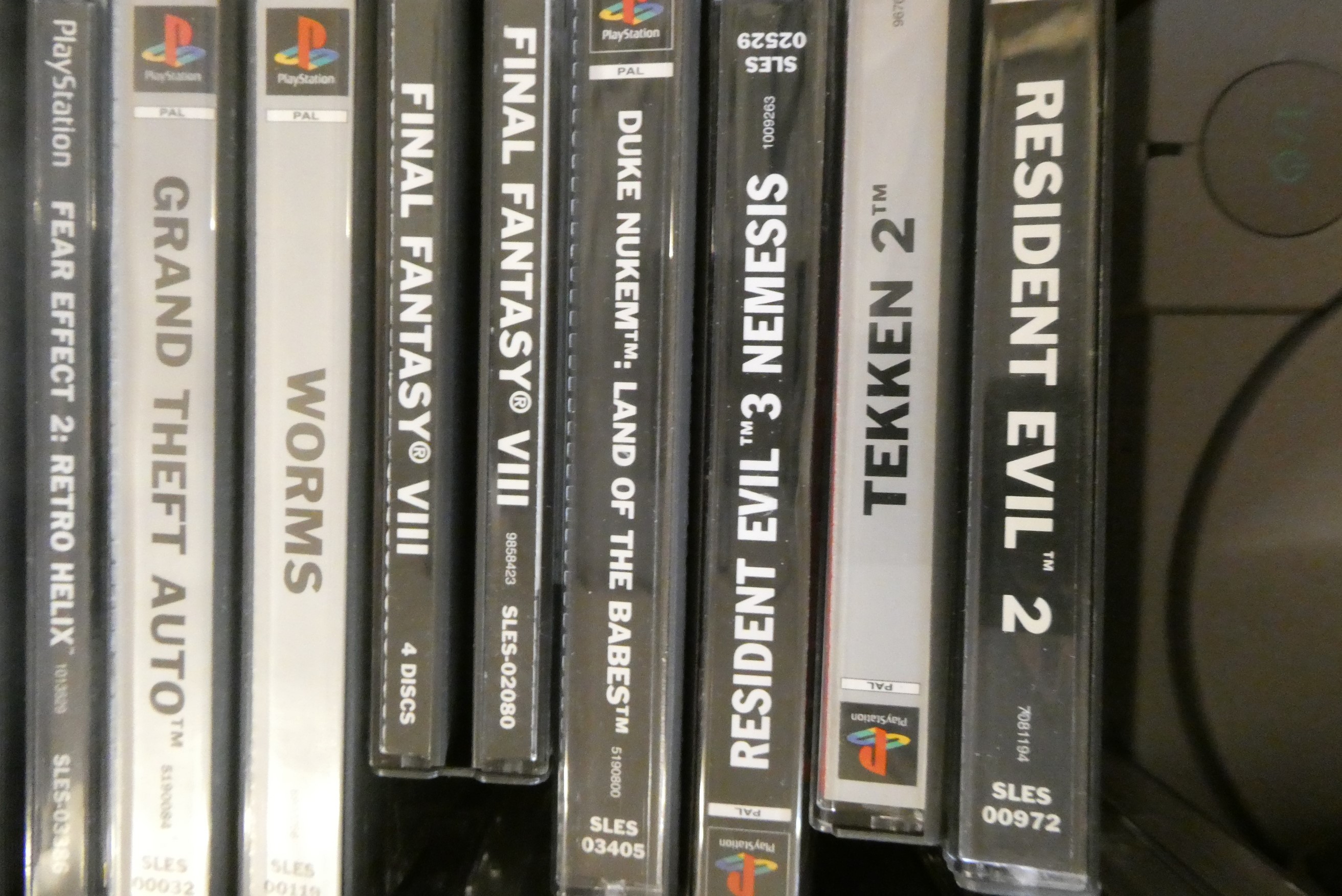 Playstation with controllers and 28 boxed games Image