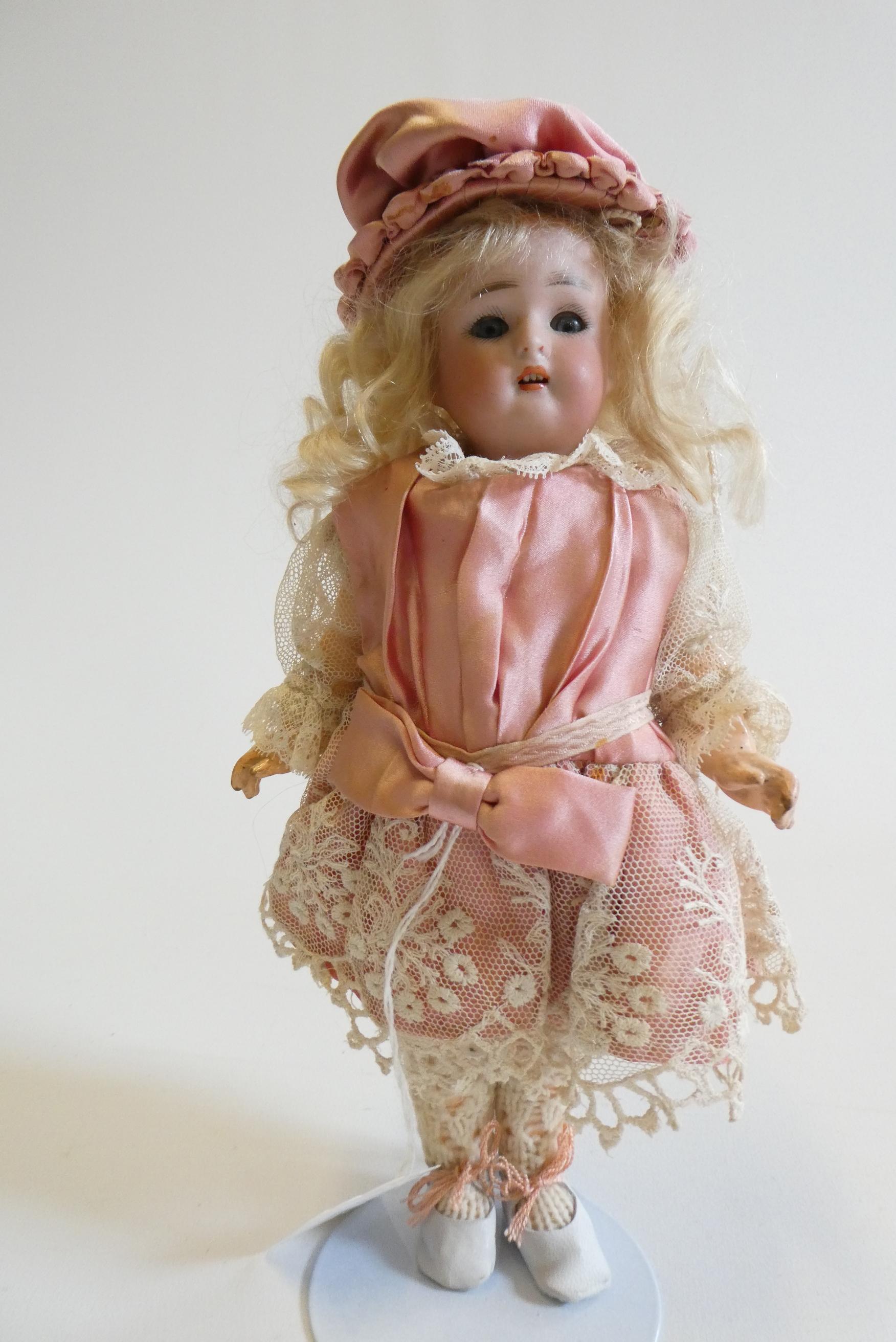 A Kammer & Reinhardt bisque socket head doll with blue glass sleeping eyes Image