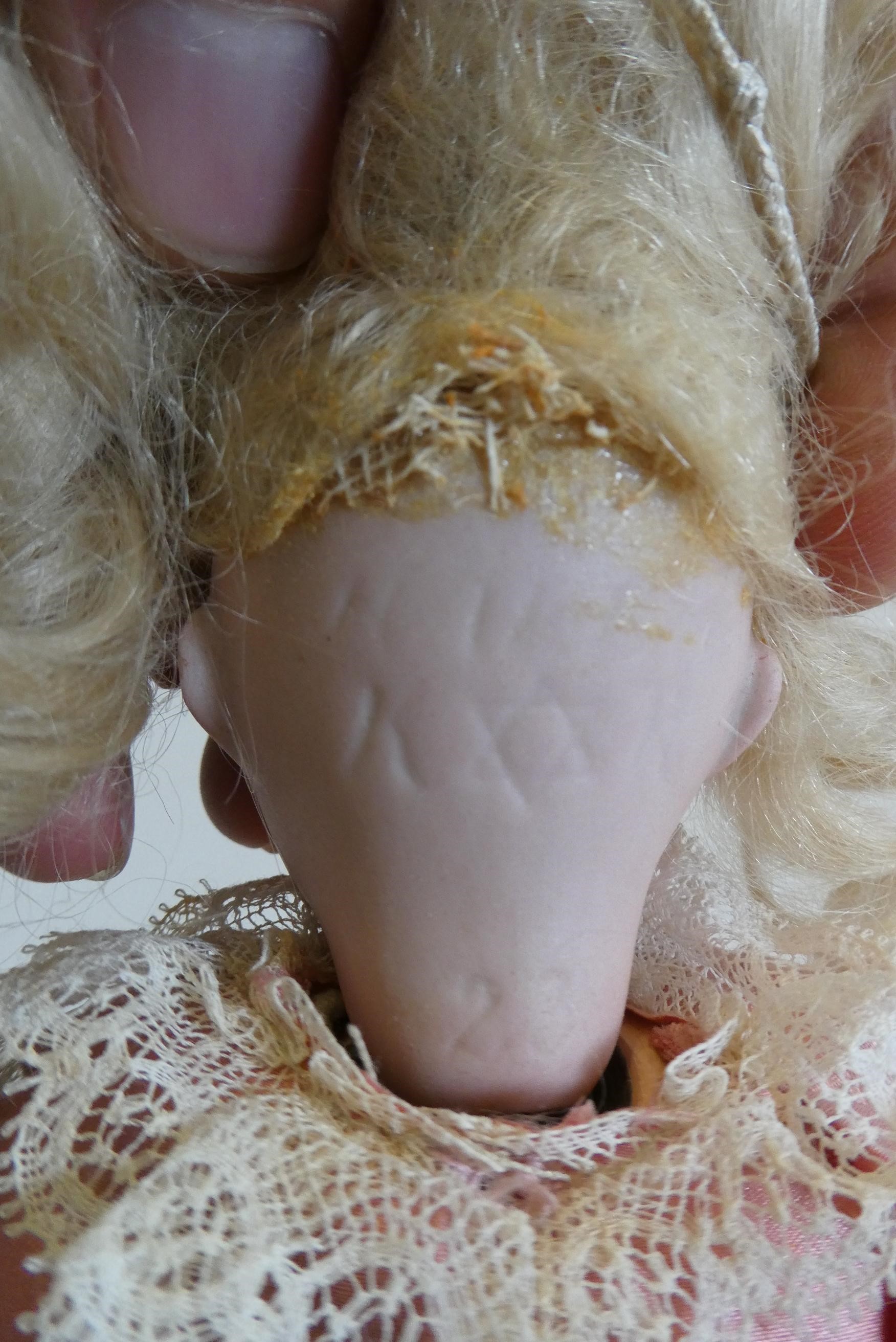 A Kammer & Reinhardt bisque socket head doll with blue glass sleeping eyes Image