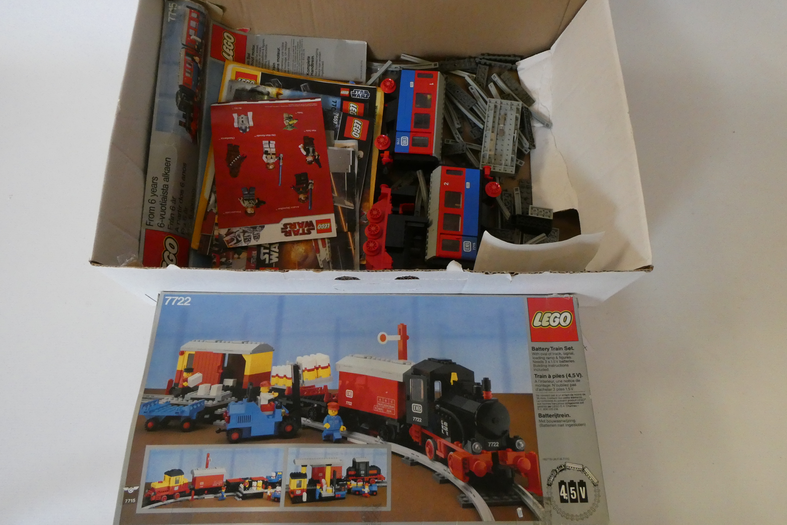Lego 7722 unboxed railway models including battery locomotives, coaches, wagons and track parts Image