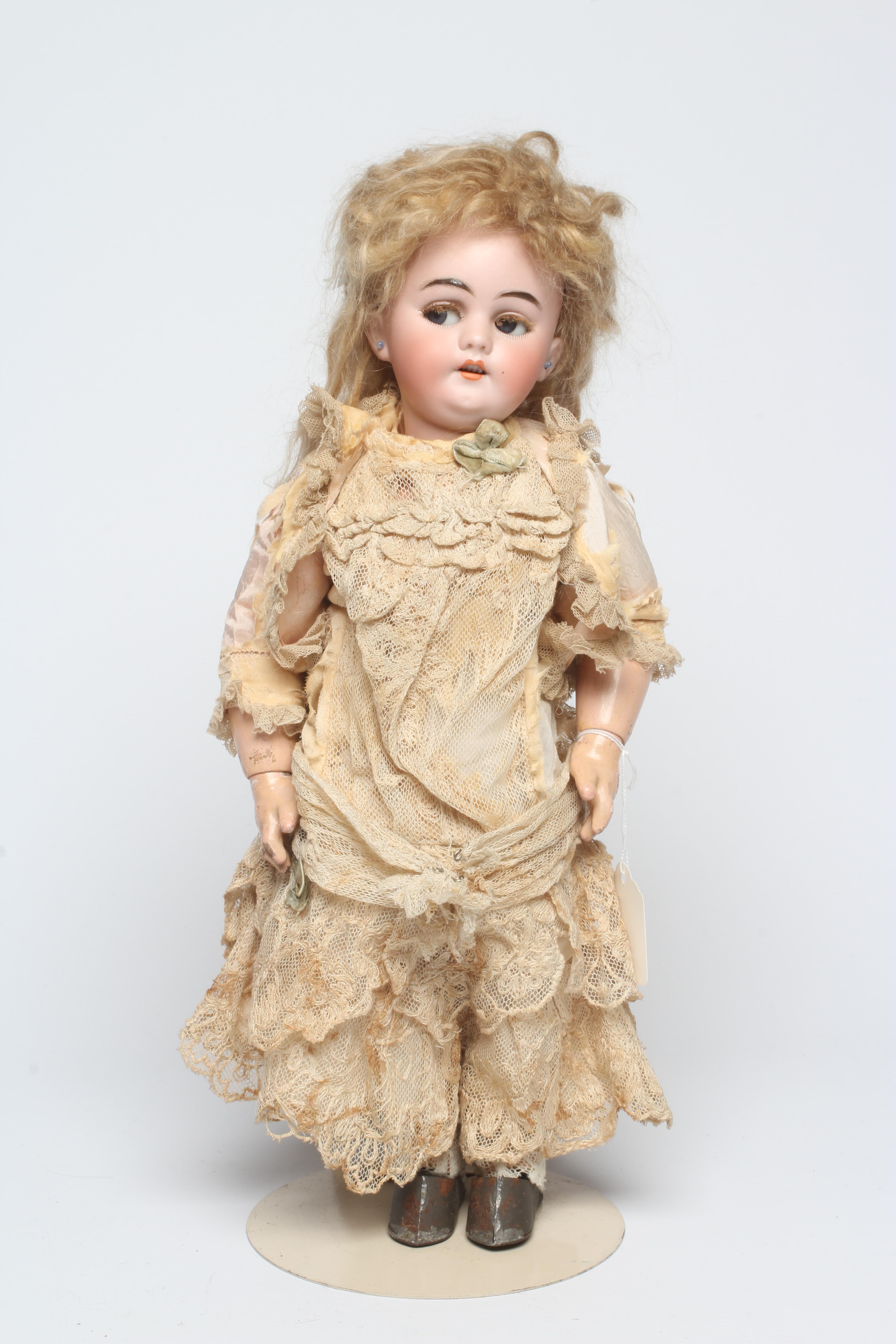 A Simon & Halbig bisque socket head clockwork walking doll with blue glass sideways glancing flirty Image