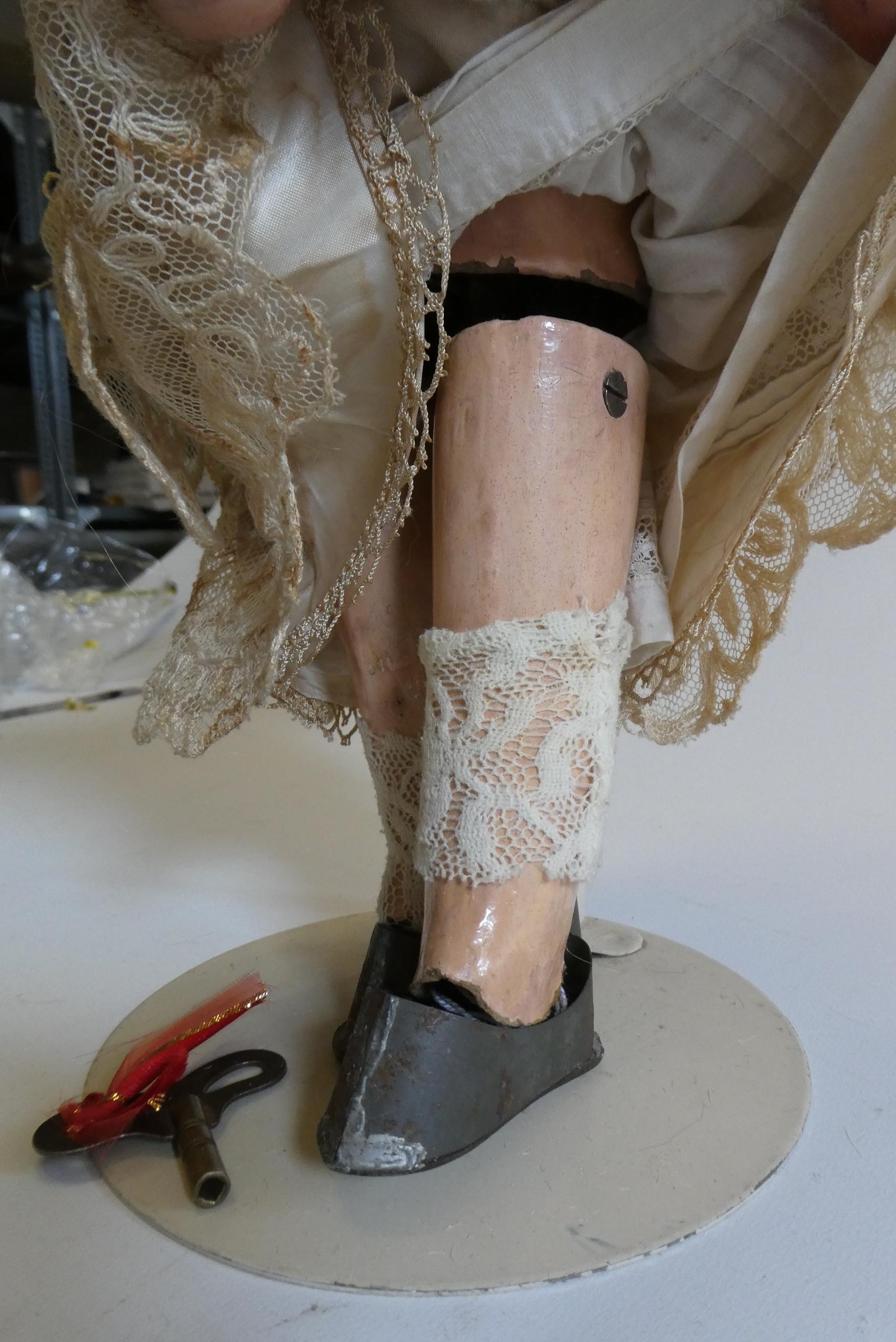 A Simon & Halbig bisque socket head clockwork walking doll with blue glass sideways glancing flirty Image