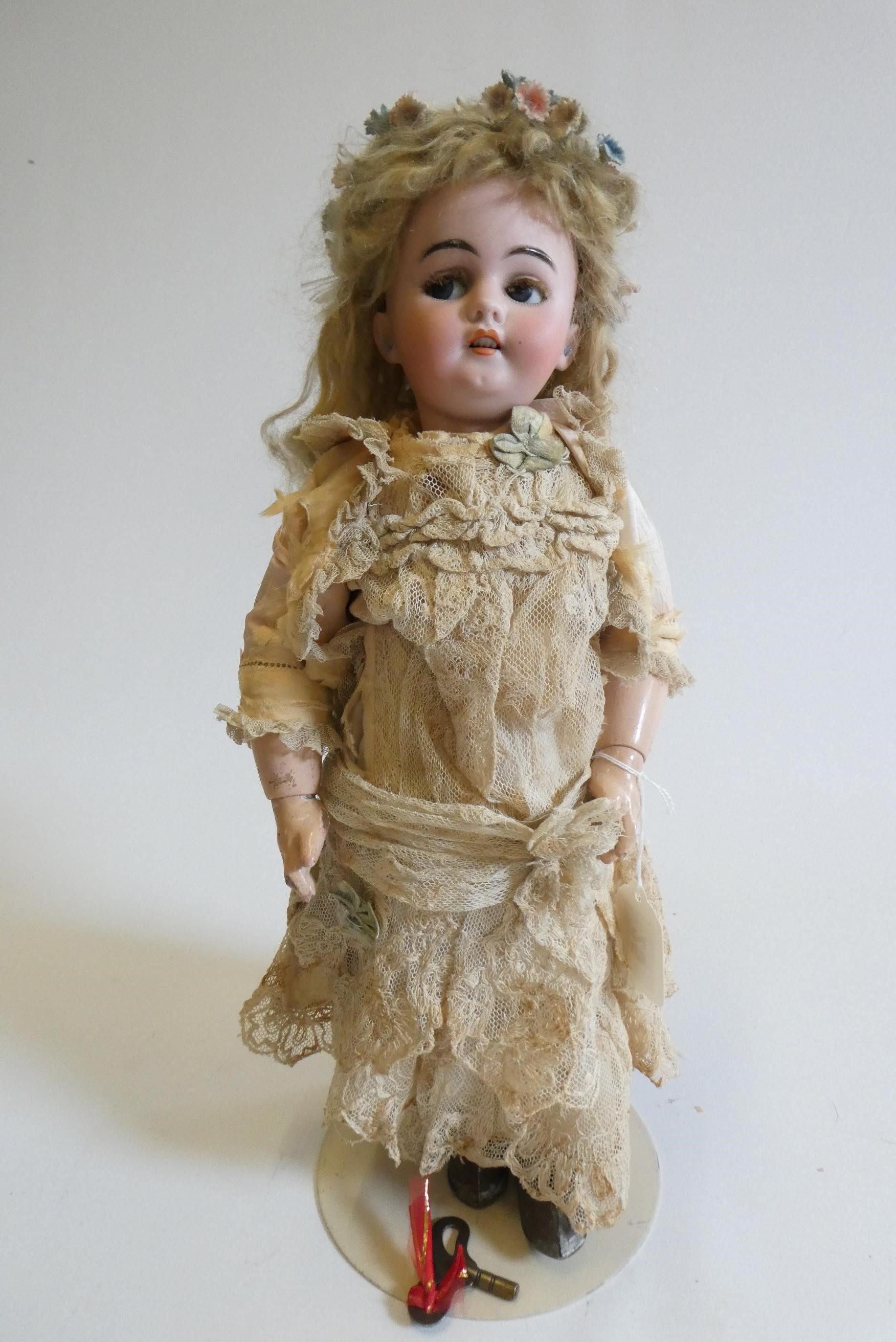 A Simon & Halbig bisque socket head clockwork walking doll with blue glass sideways glancing flirty Image