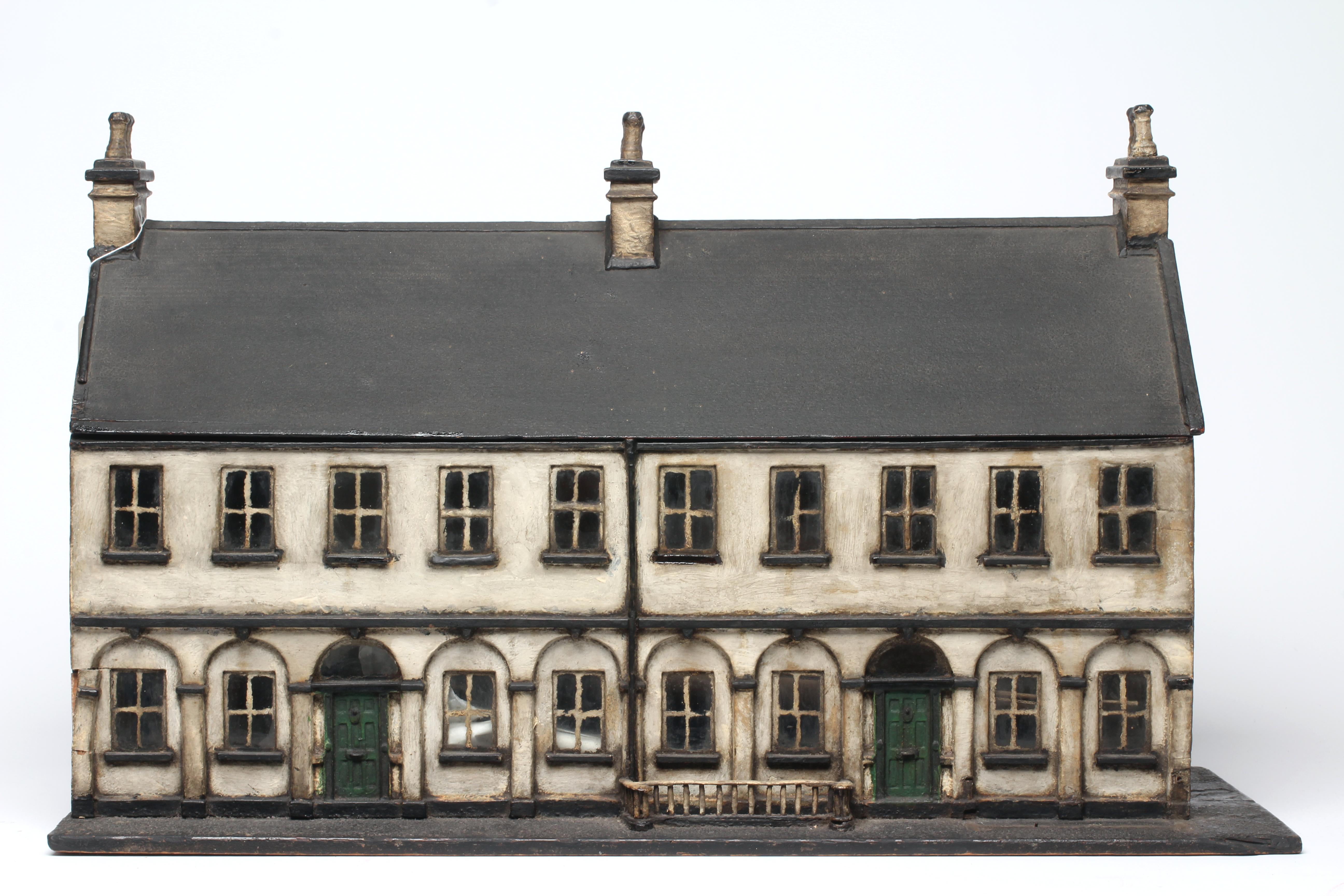 A Victorian doll's house/trunk in the form of a two house street Image