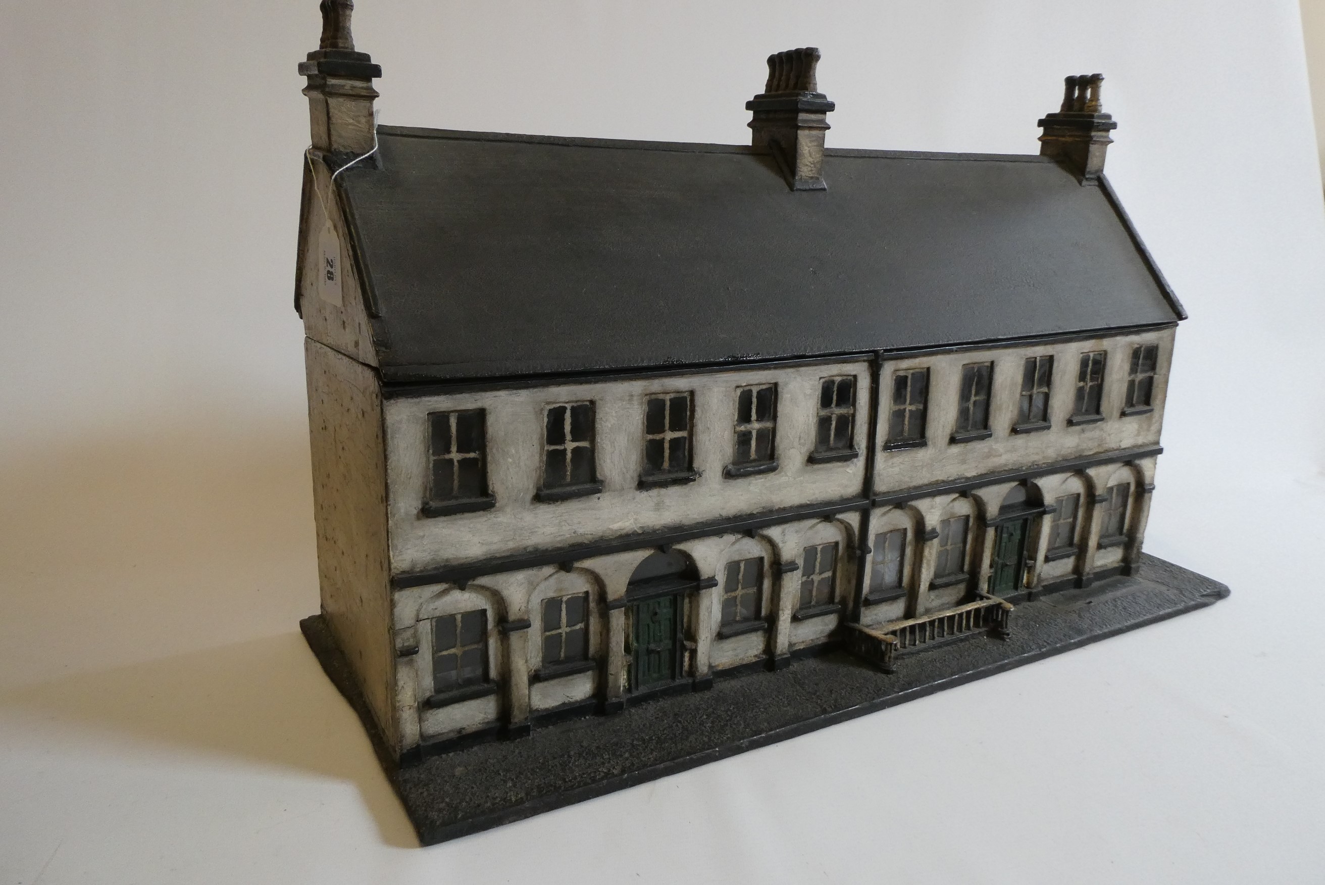 A Victorian doll's house/trunk in the form of a two house street Image