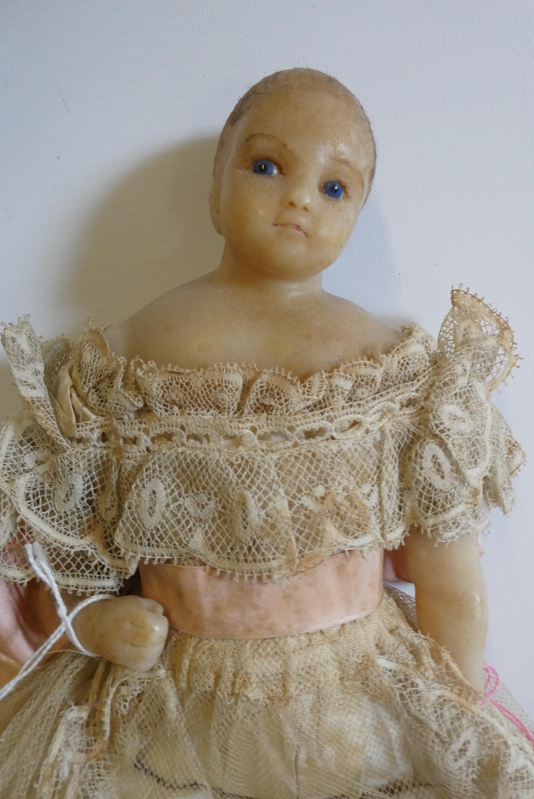 A poured wax shoulder head doll Image