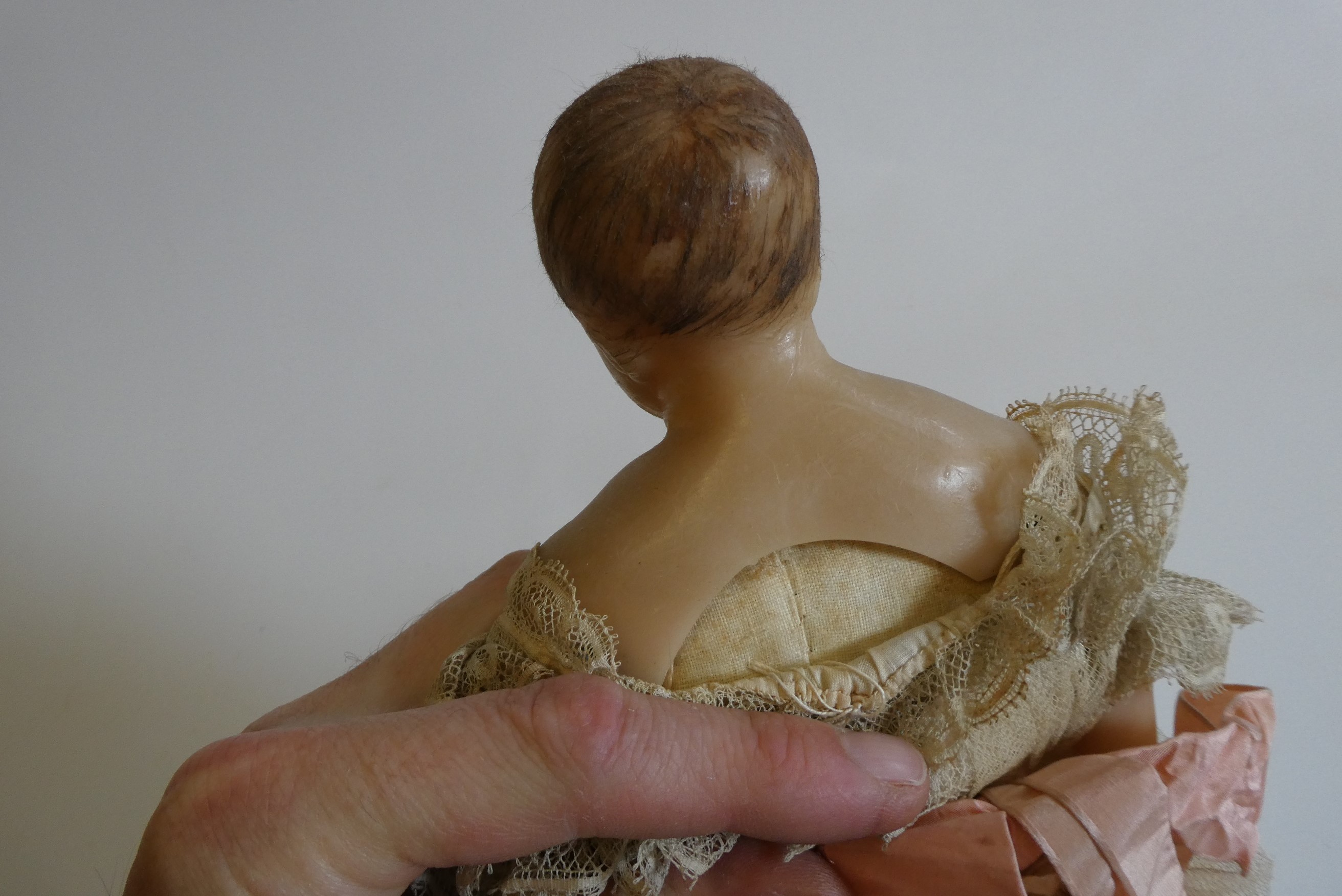 A poured wax shoulder head doll Image