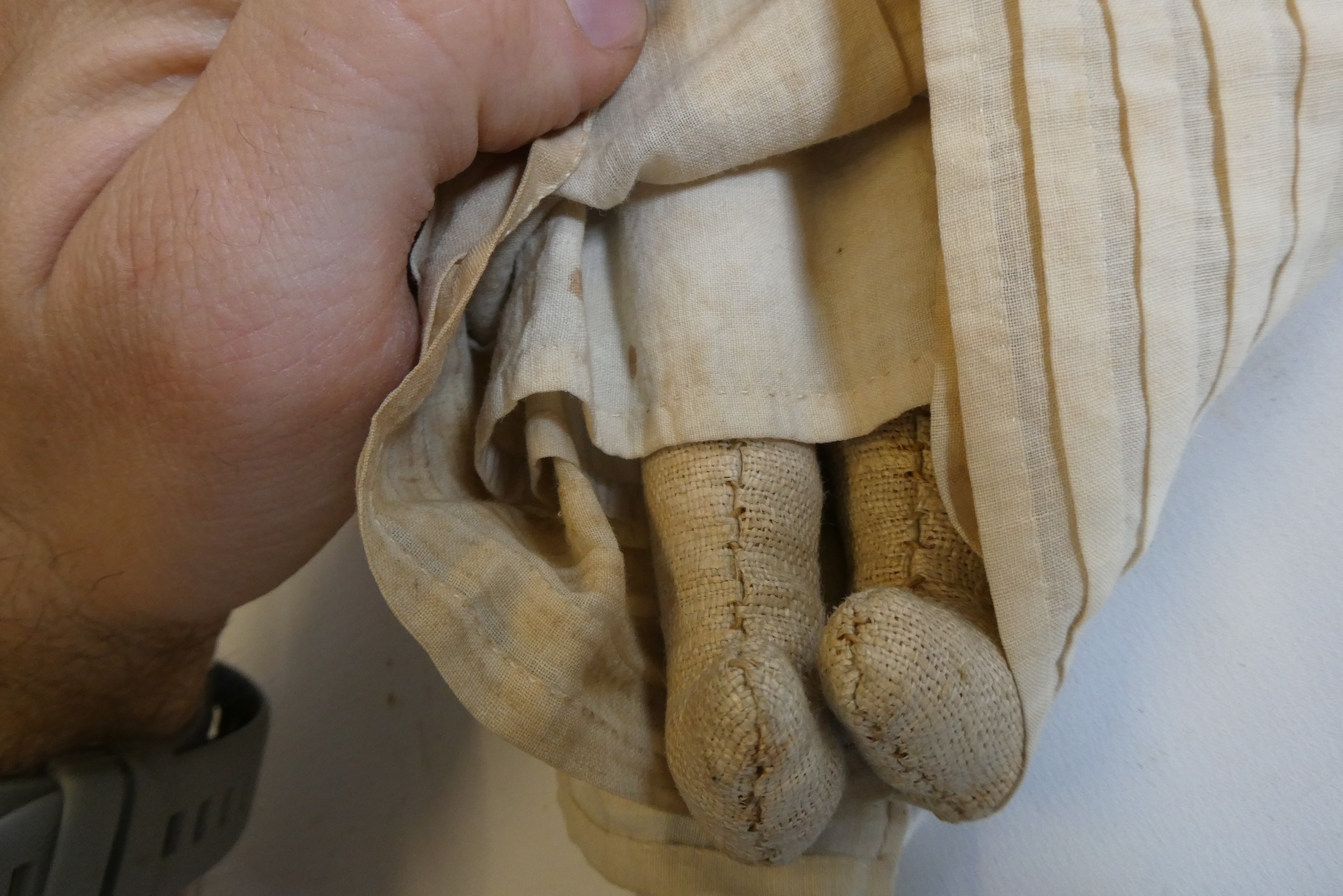 A Victorian wax shoulder head doll with blue glass fixed eyes, moulded open mouth, blond wig, fabric Image