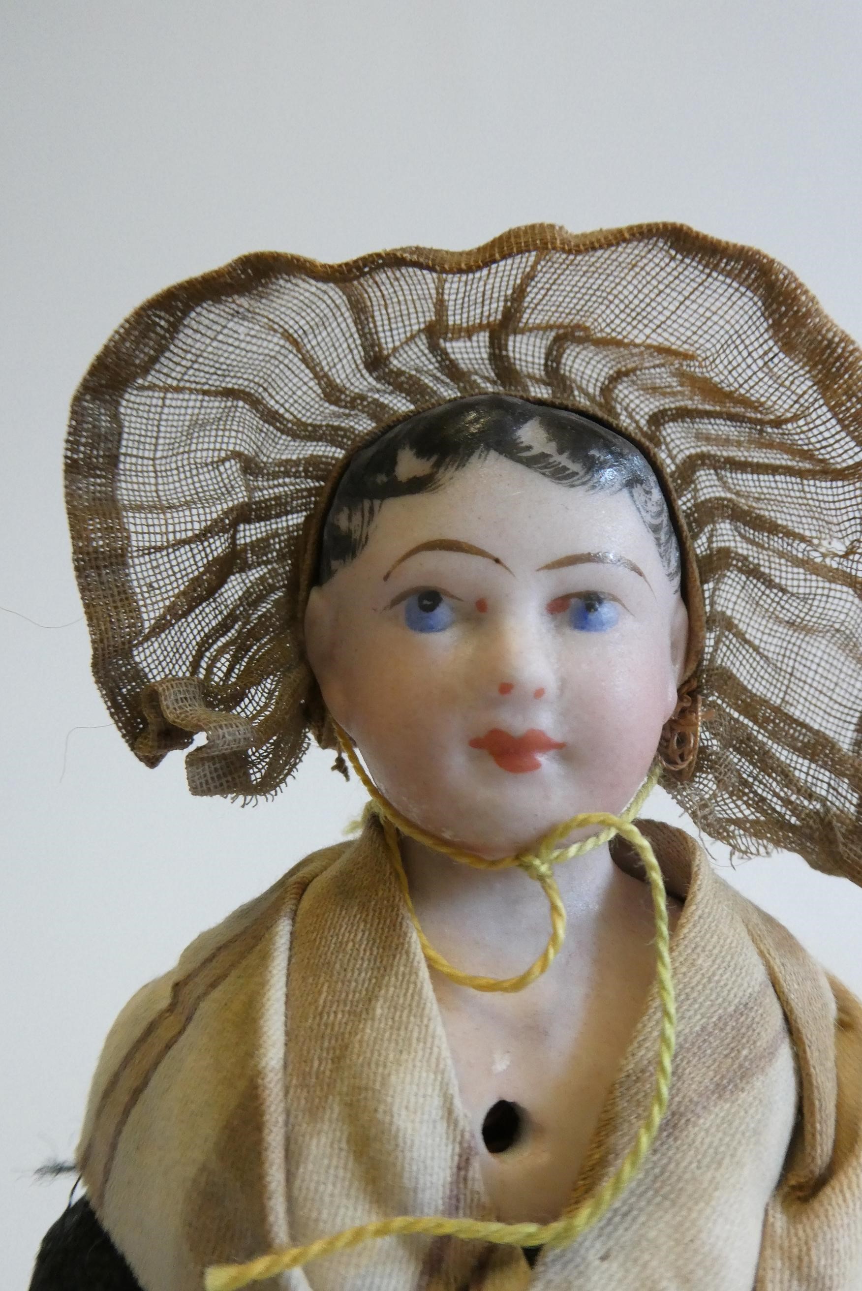 A possibly Francois Gaultier fisherwoman bisque shoulder head doll with blue moulded eyes Image