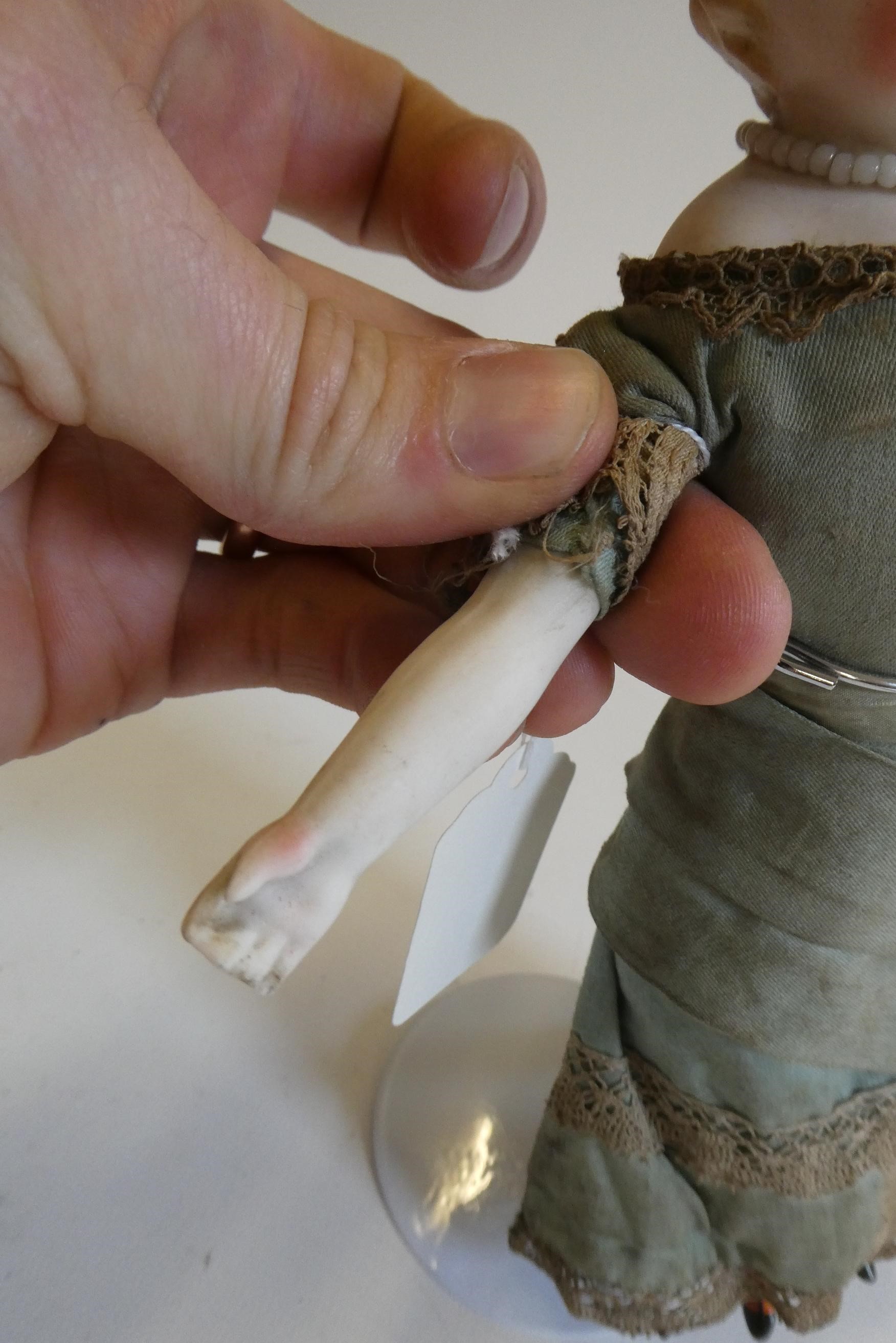 A bisque shoulder head doll, 19th century, with painted features, moulded hair, fabric body, bisque Image