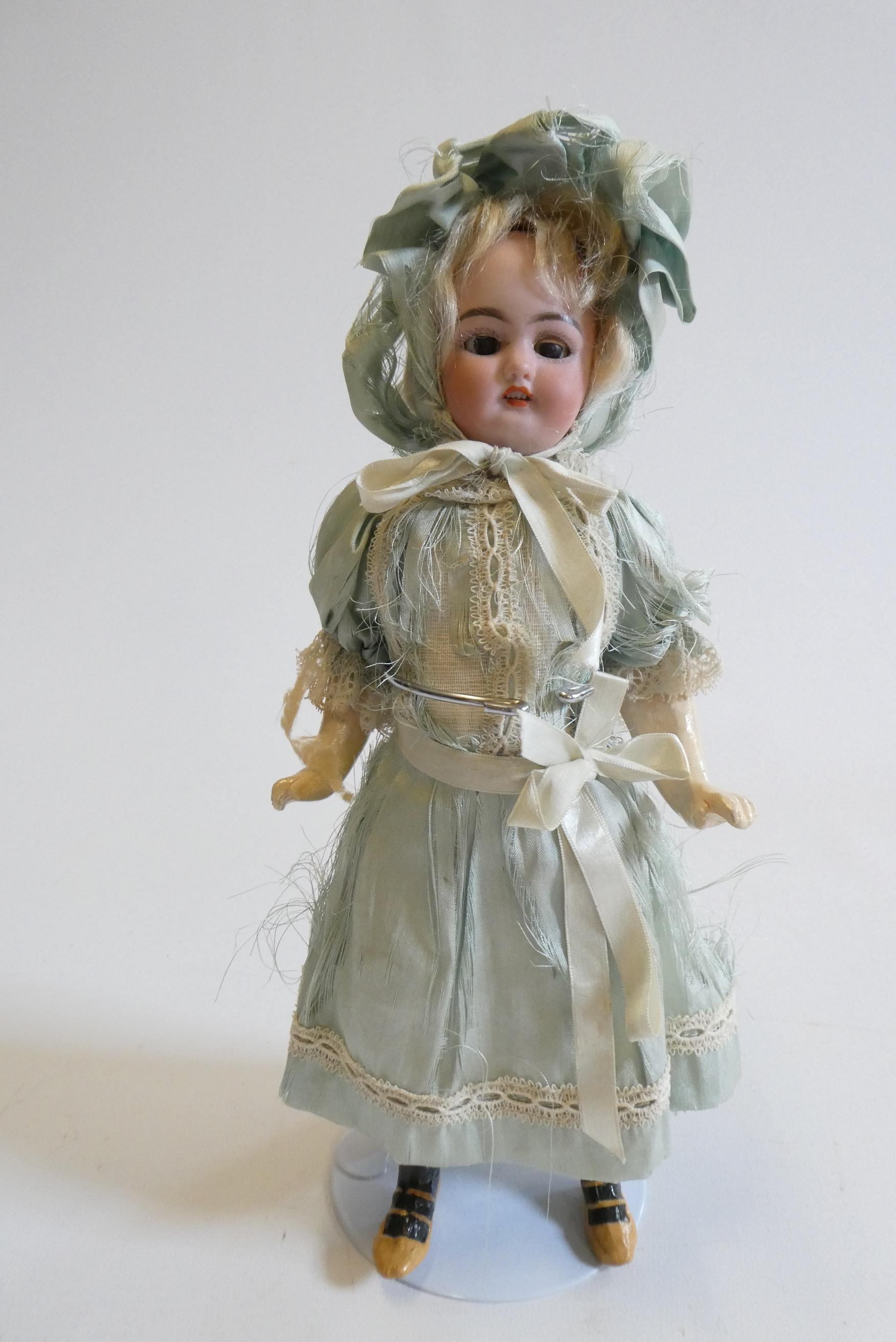 A Simon & Halbig bisque socket head doll with brown glass sleeping eyes Image