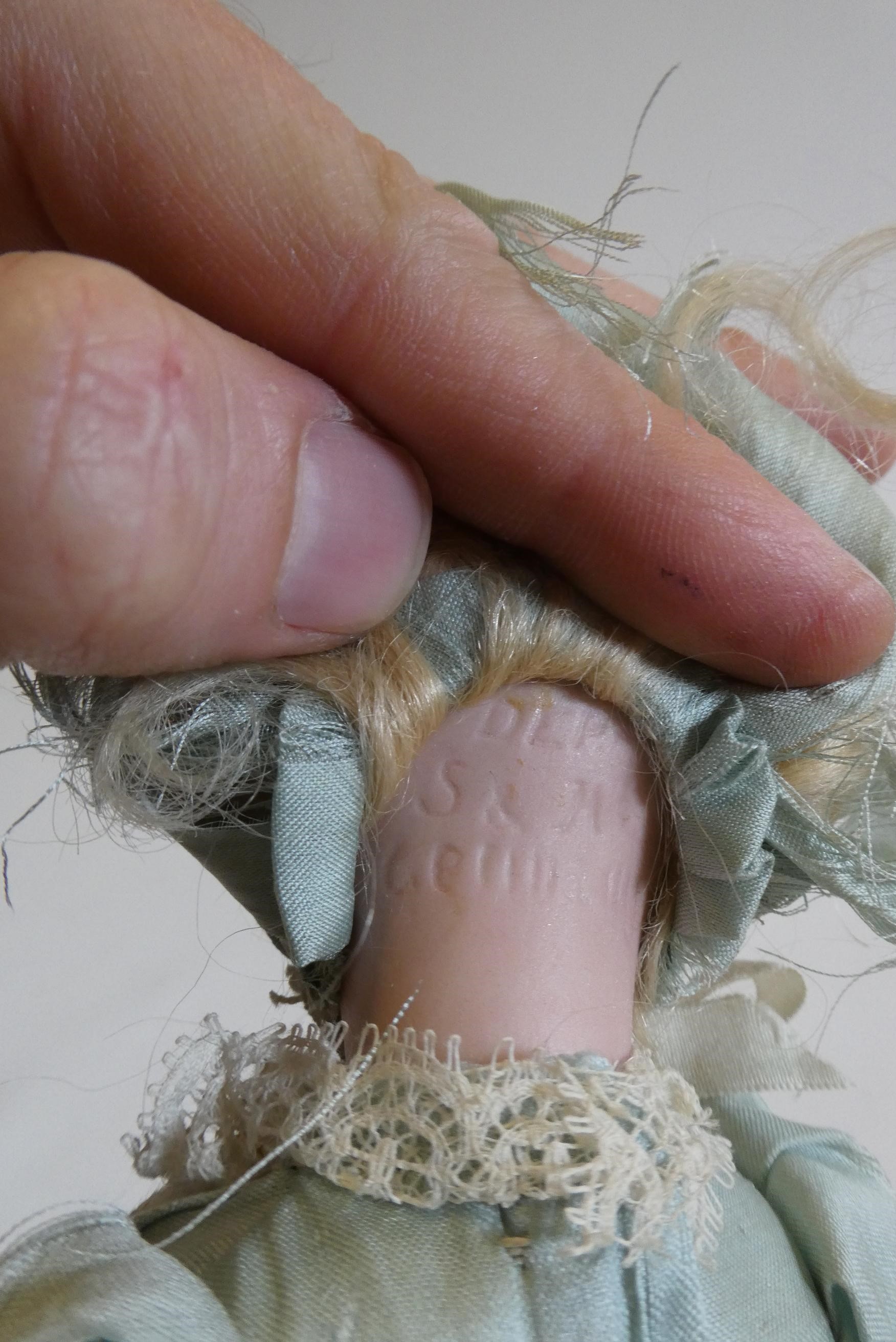 A Simon & Halbig bisque socket head doll with brown glass sleeping eyes Image