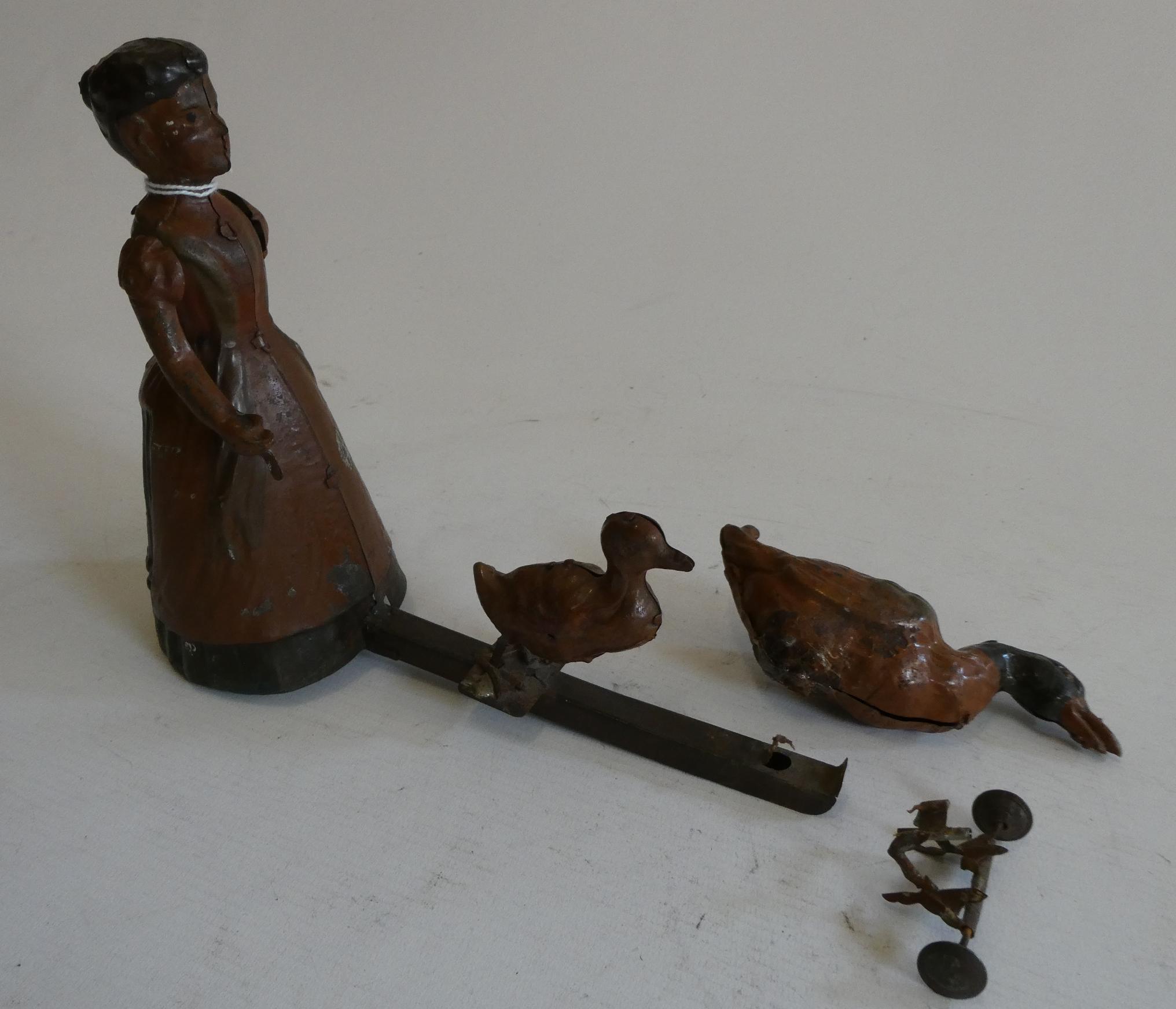 Unidentified German clockwork Housewife herding ducks, some parts detached and paint damage, fair Image
