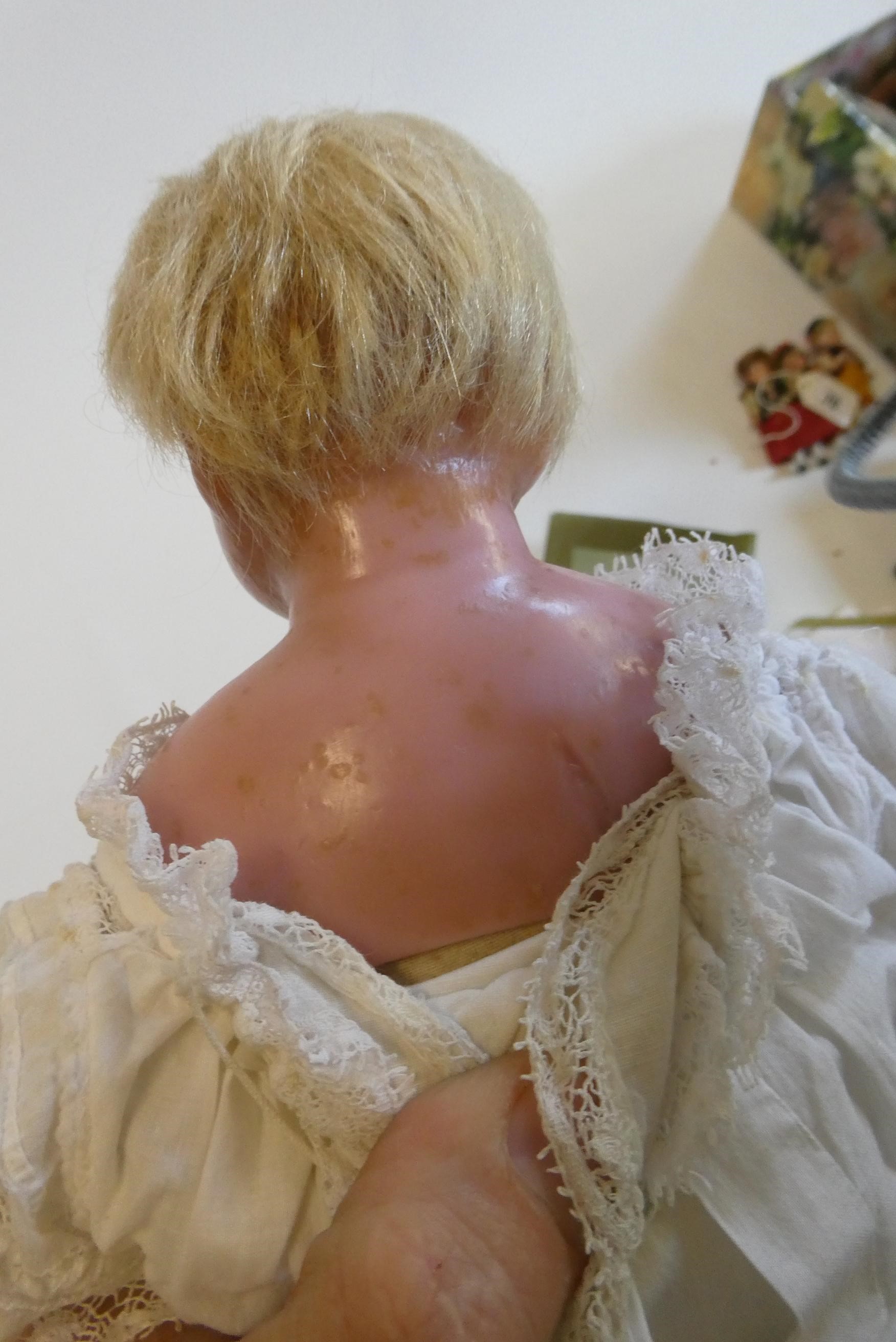 A Victorian wax shoulder head doll, with blue glass paperweight eyes, closed mouth, inserted blond Image