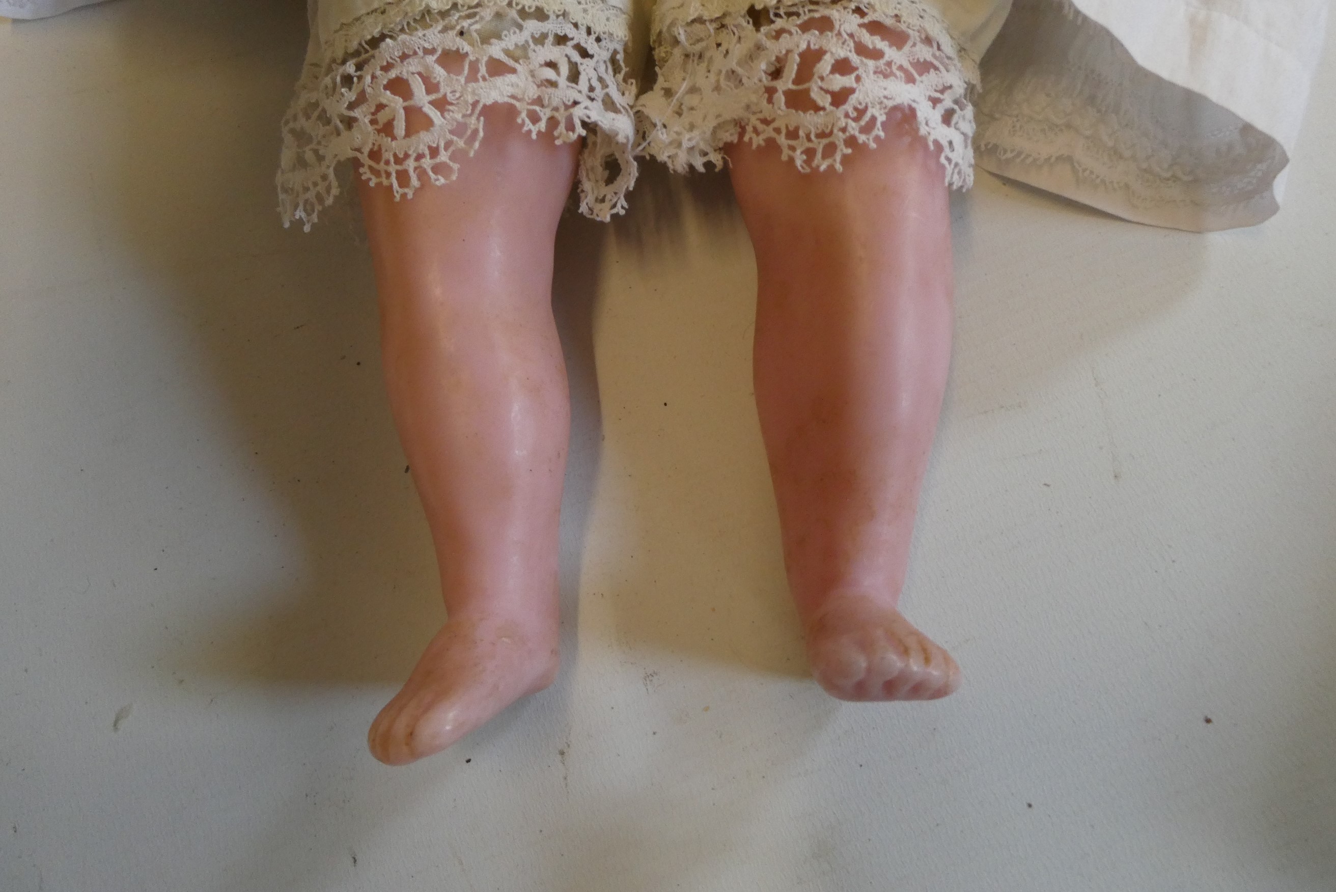 A Victorian wax shoulder head doll, with blue glass paperweight eyes, closed mouth, inserted blond Image