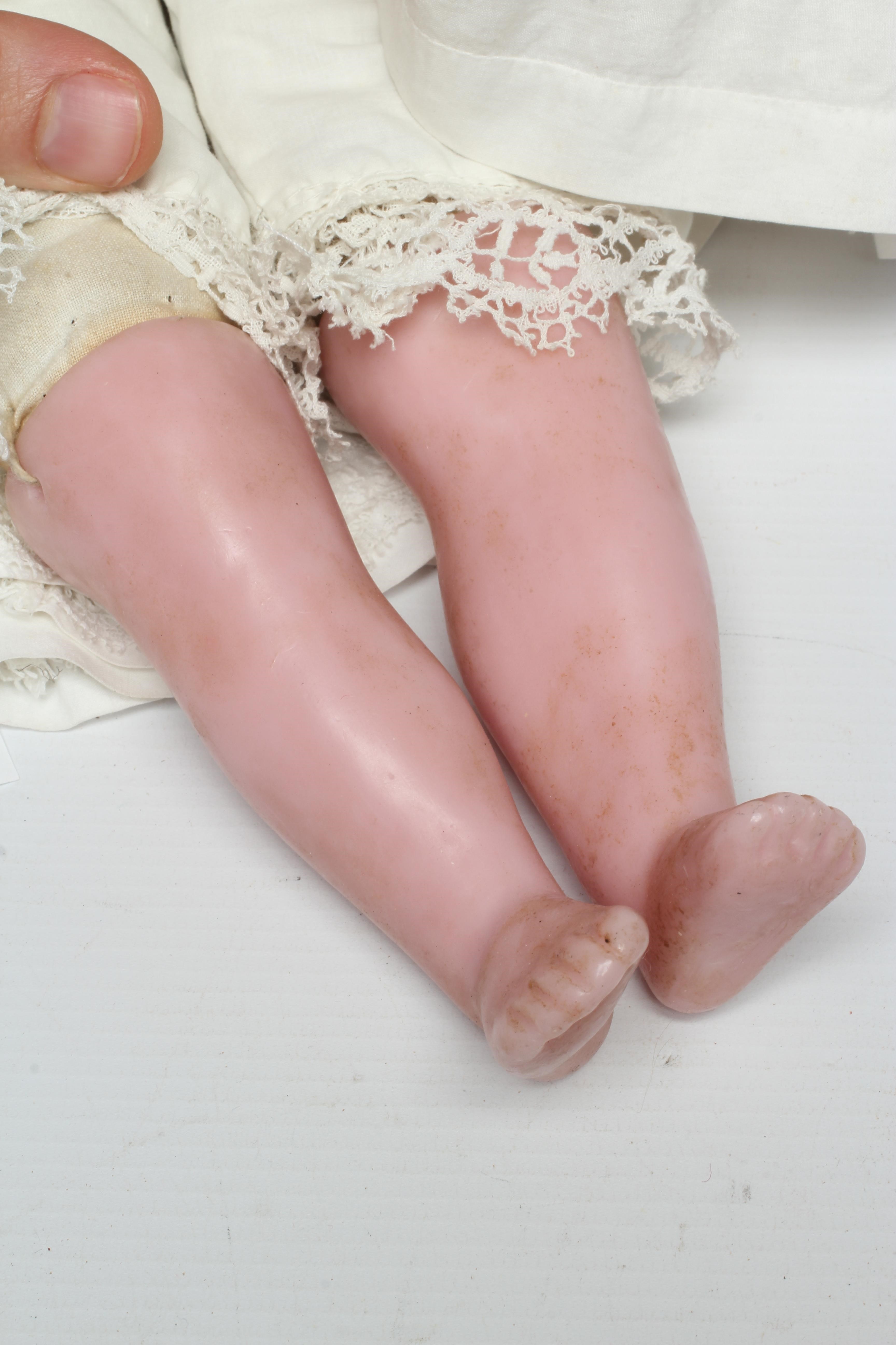 A Victorian wax shoulder head doll, with blue glass paperweight eyes, closed mouth, inserted blond Image